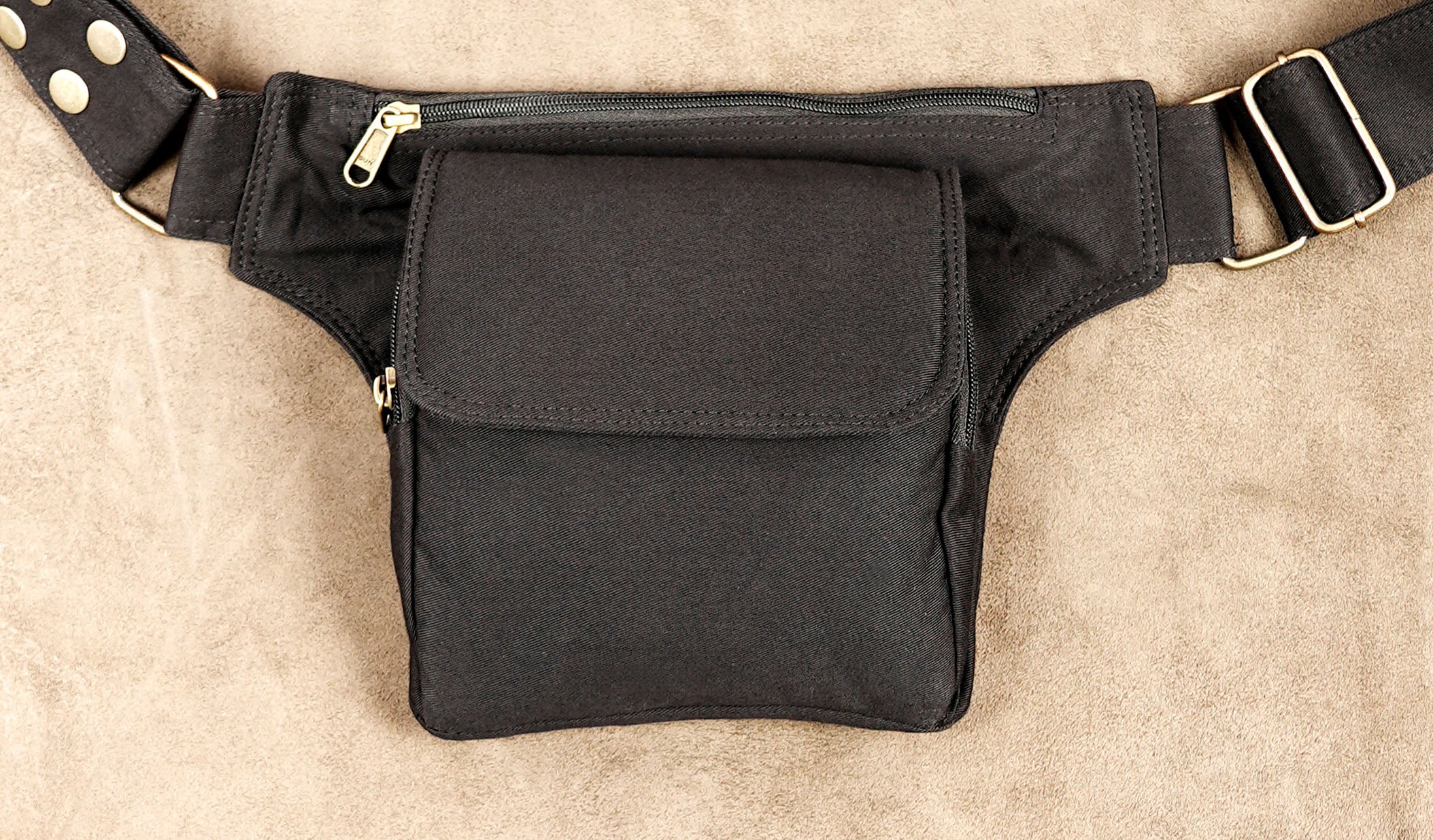 Black canvas holster hip bag with flap closure and side zipper