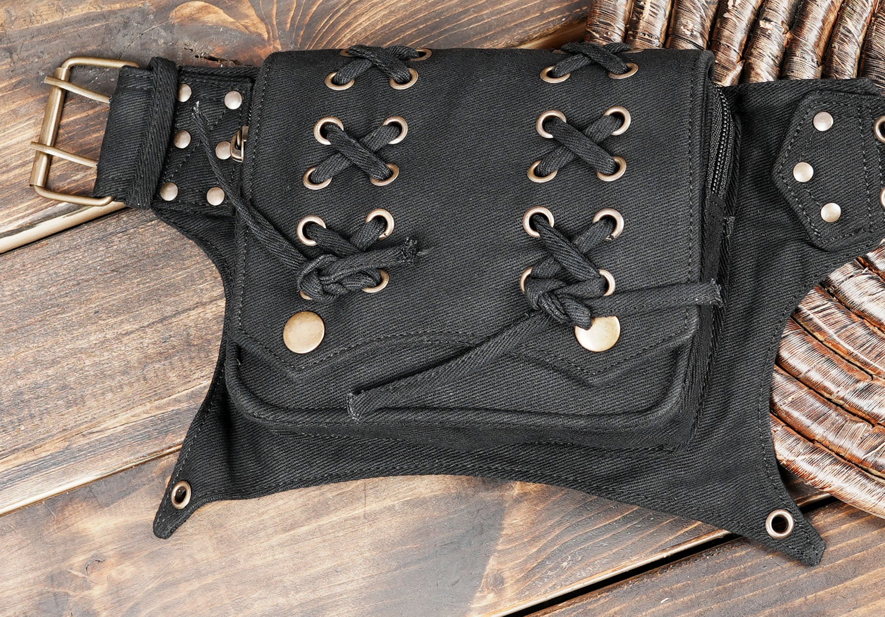 Adjustable black hip belt with industrial grommets and storage pouches.