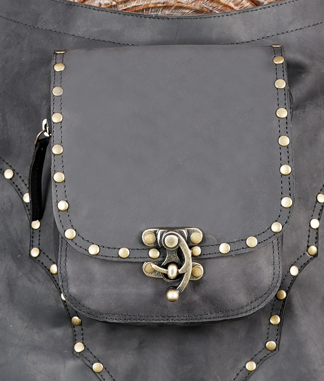 Built-in utility pocket with secure clasp closure for carrying essentials hands-free