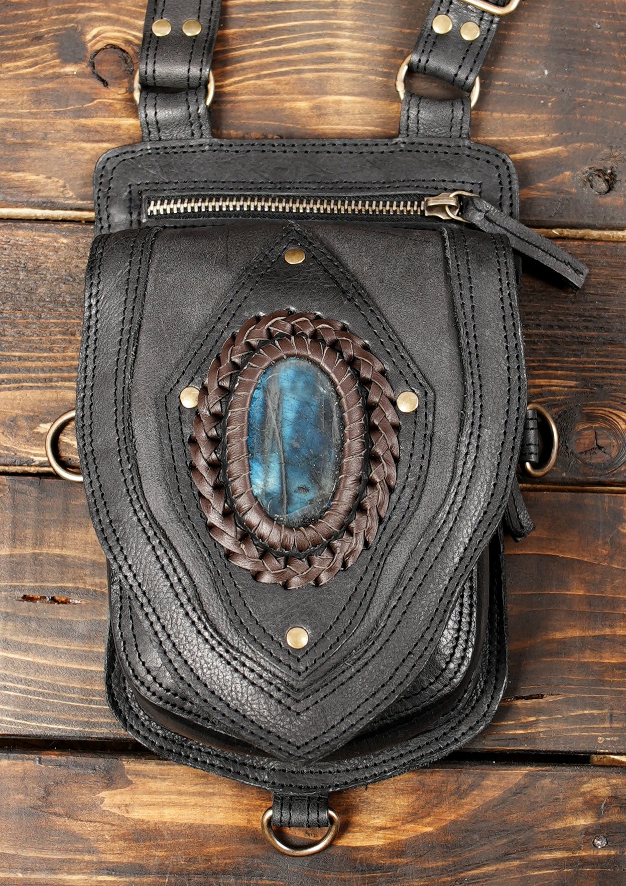Artisan leather harness bag with gemstone centerpiece.