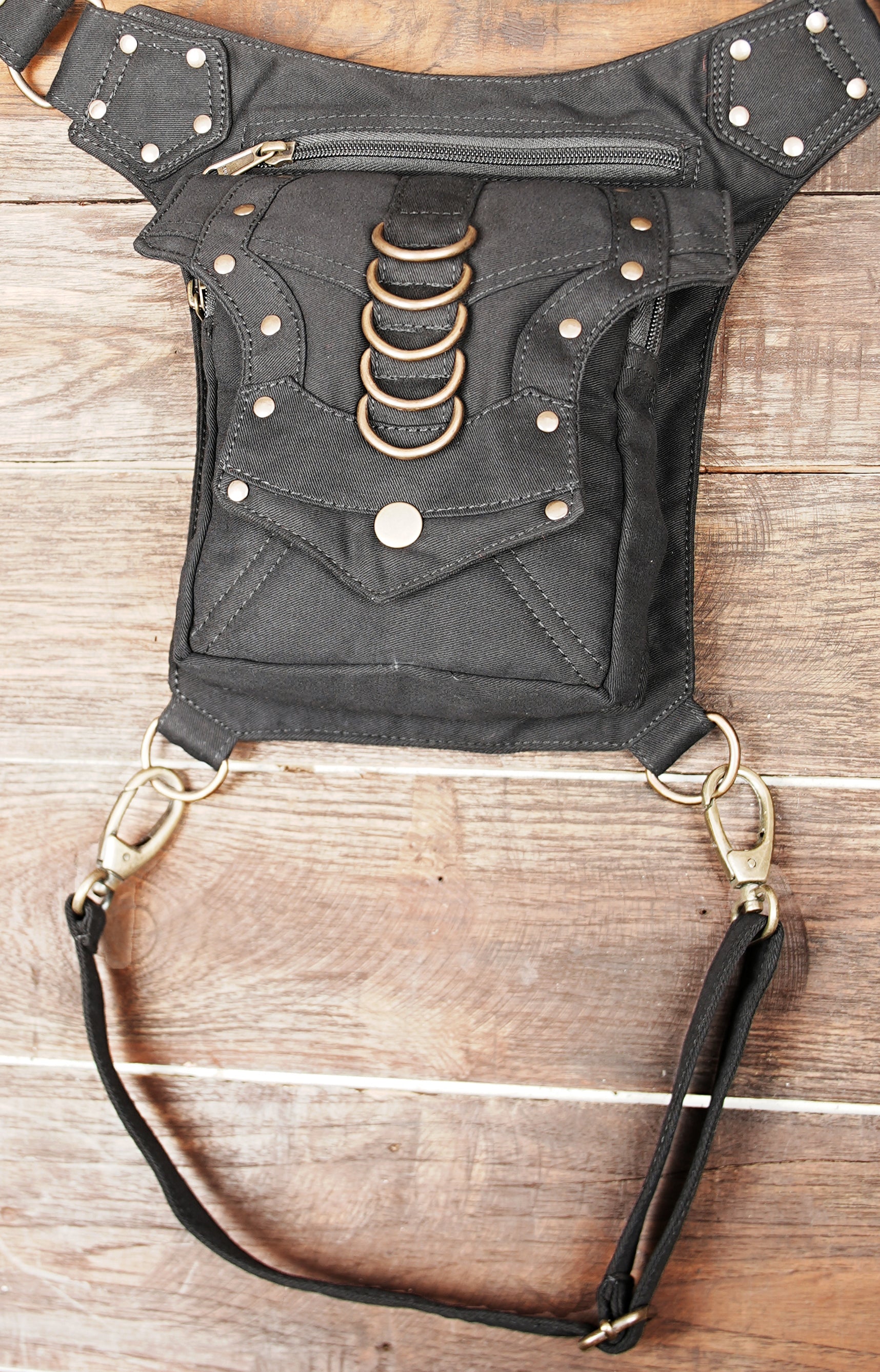 Festival thigh pocket belt with adjustable leg strap and decorative brass hardware.