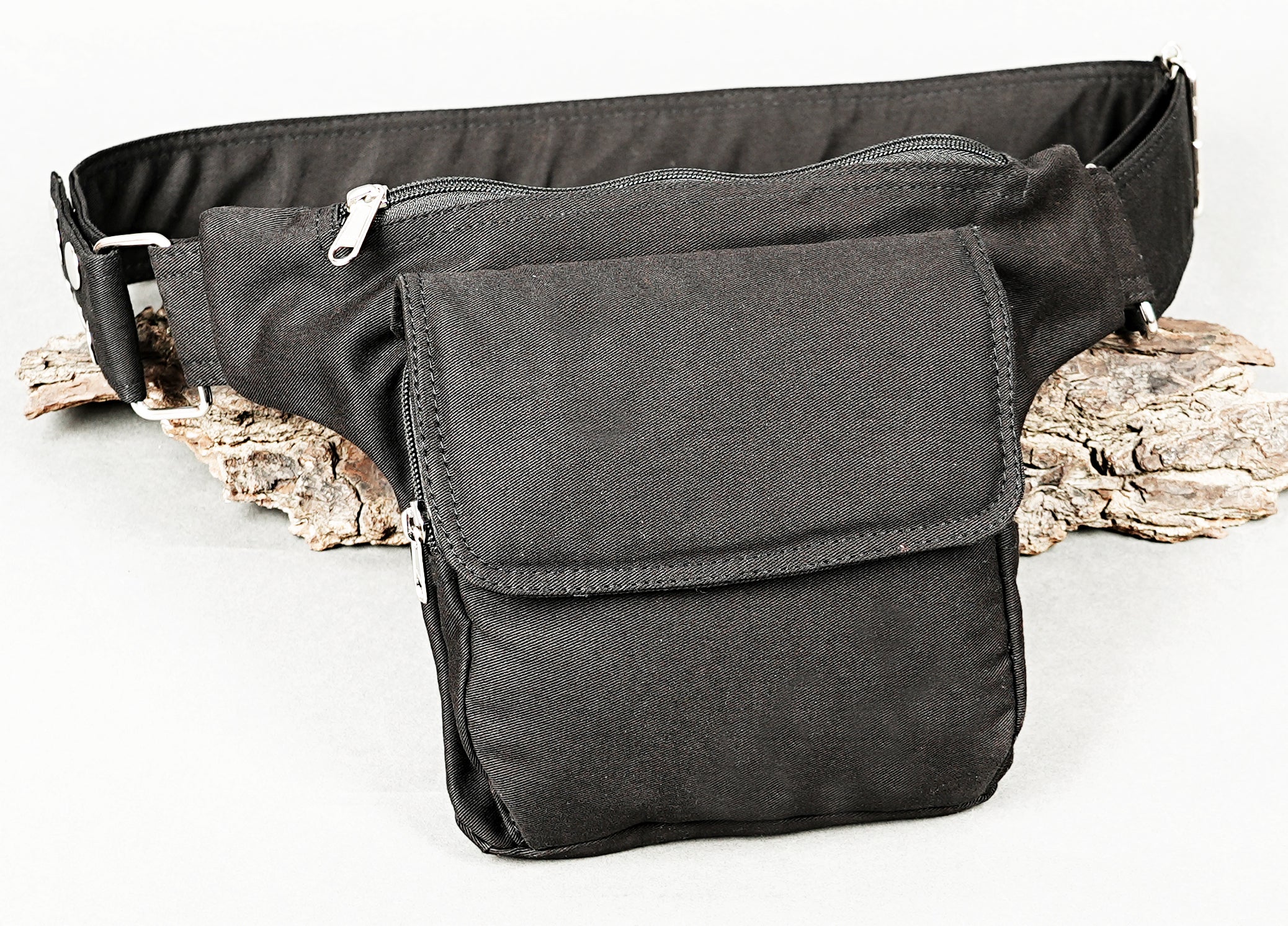 Unisex black hip belt bag featuring a durable woven texture and metal hardware.