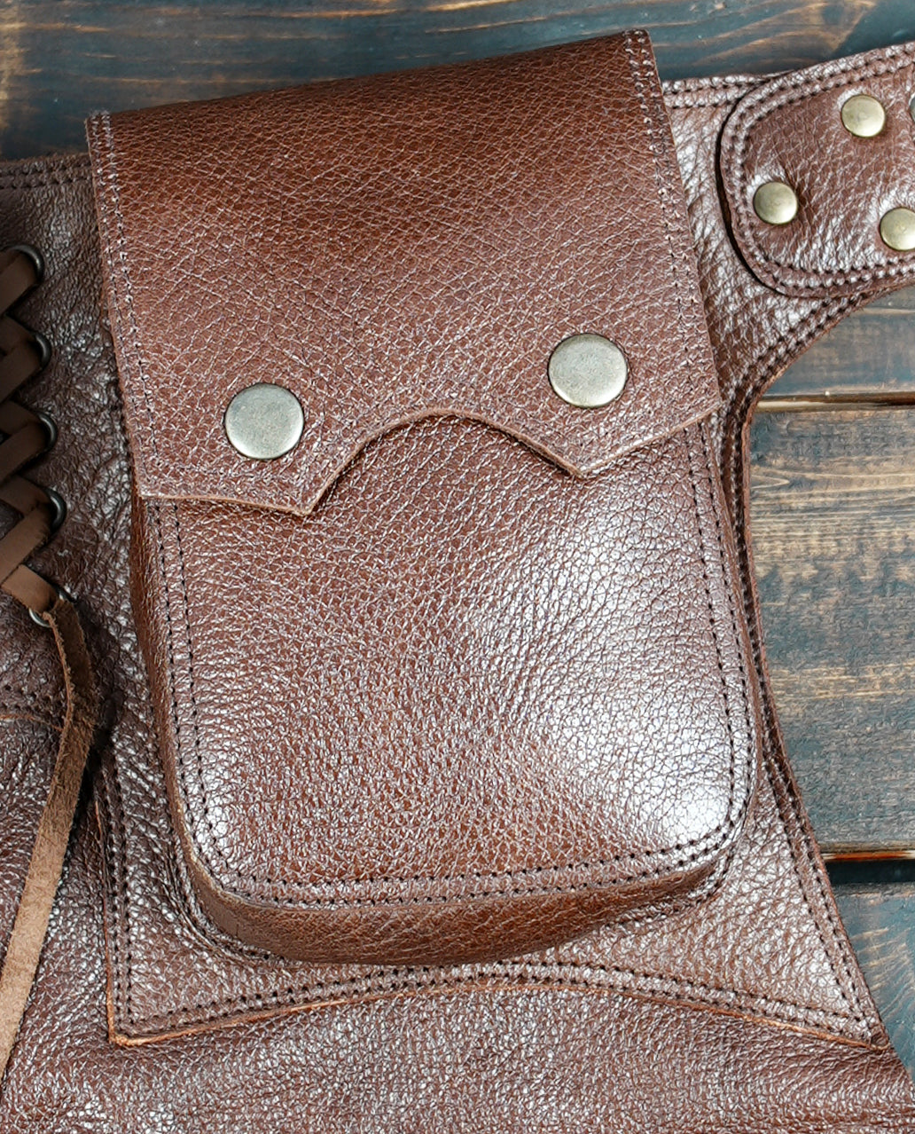 Rustic leather utility skirt with adjustable waist and brass fittings, perfect for cosplay.