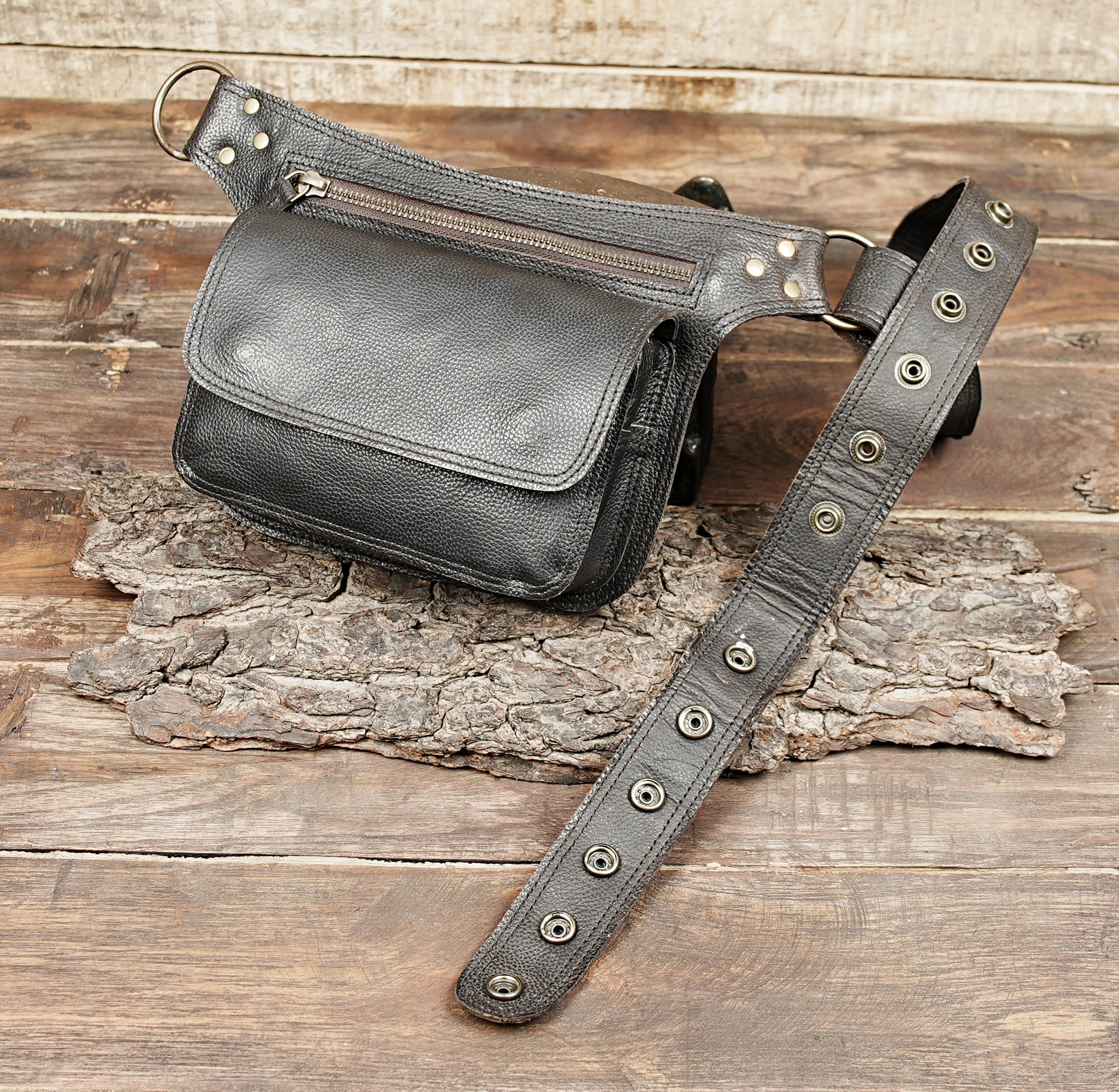 Handmade unisex leather waist bag on wooden background