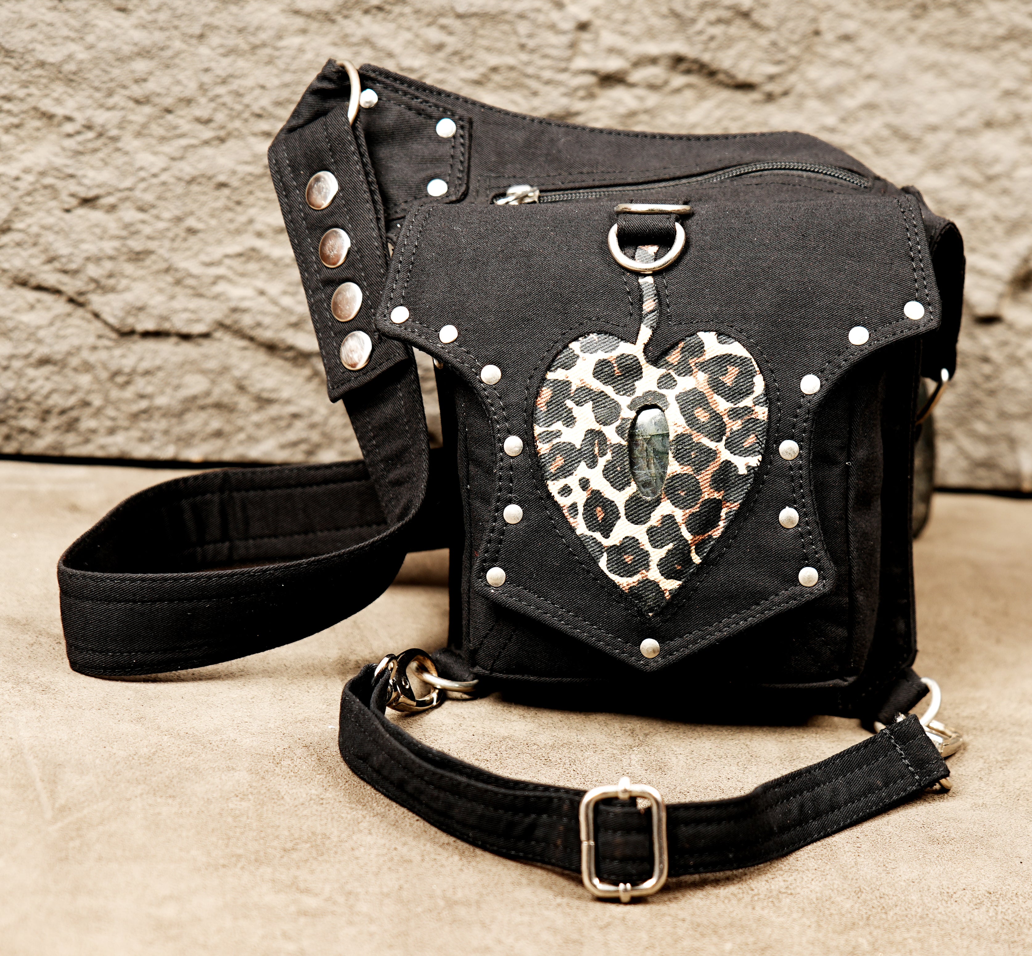 Black canvas utility bag designed to be worn around the waist and secured to the upper leg.