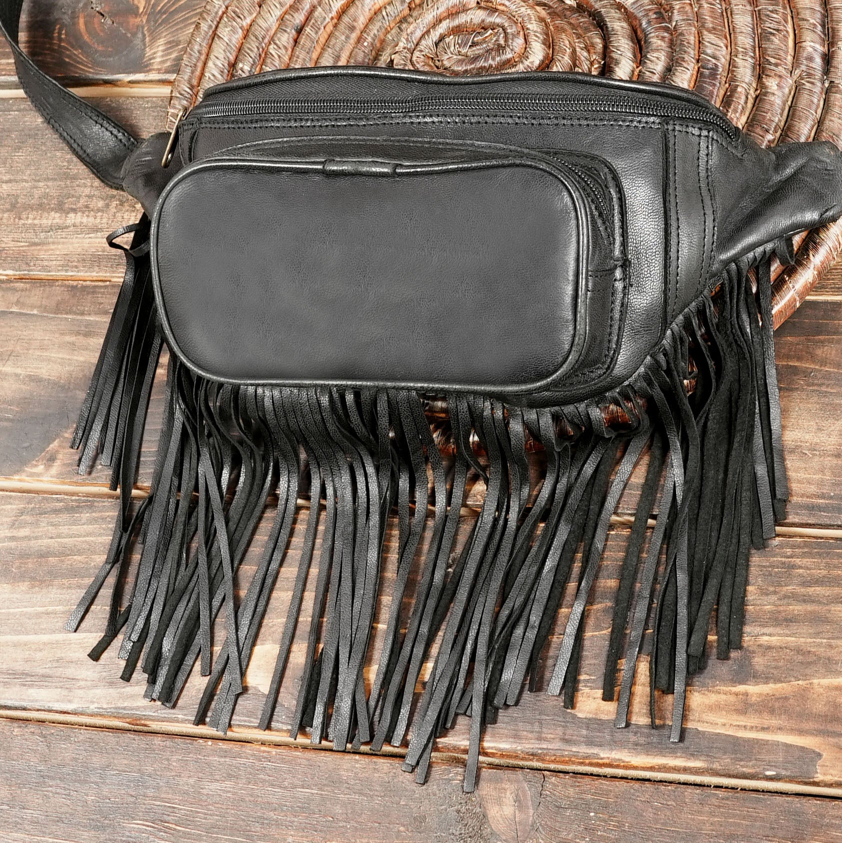 Handmade black leather hip bag with long fringe tassels