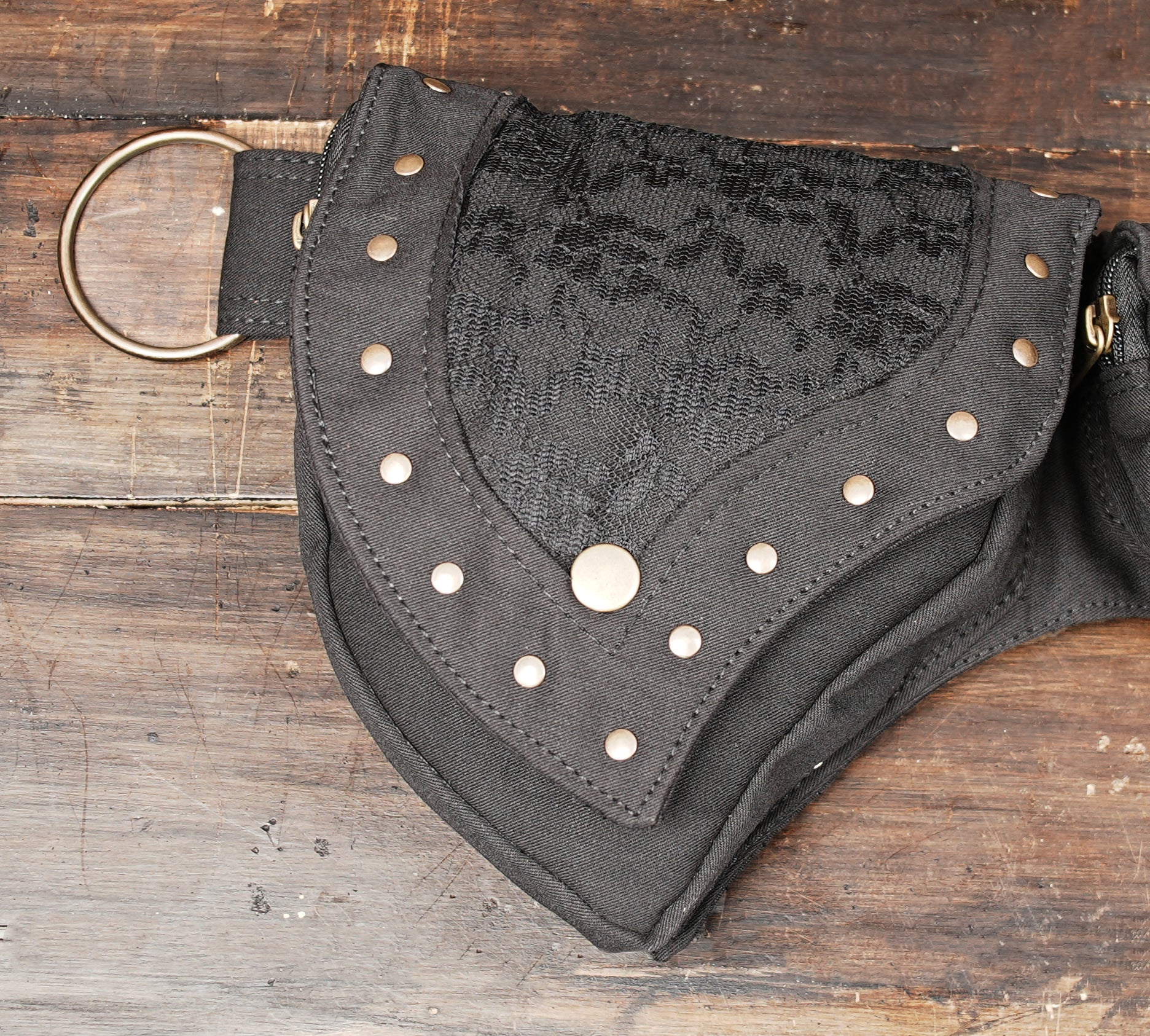 Alternative rave bum bag with pointed flap pockets on rustic wooden surface