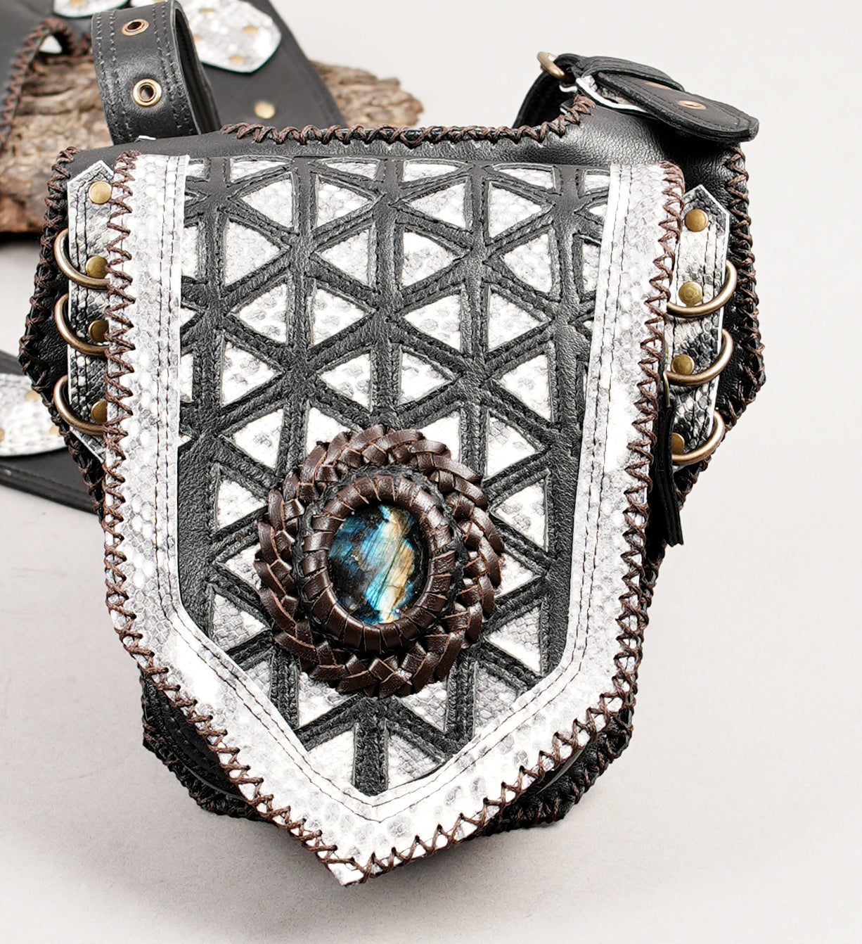 Designer leather shoulder rig with metallic panels and gemstone centerpiece