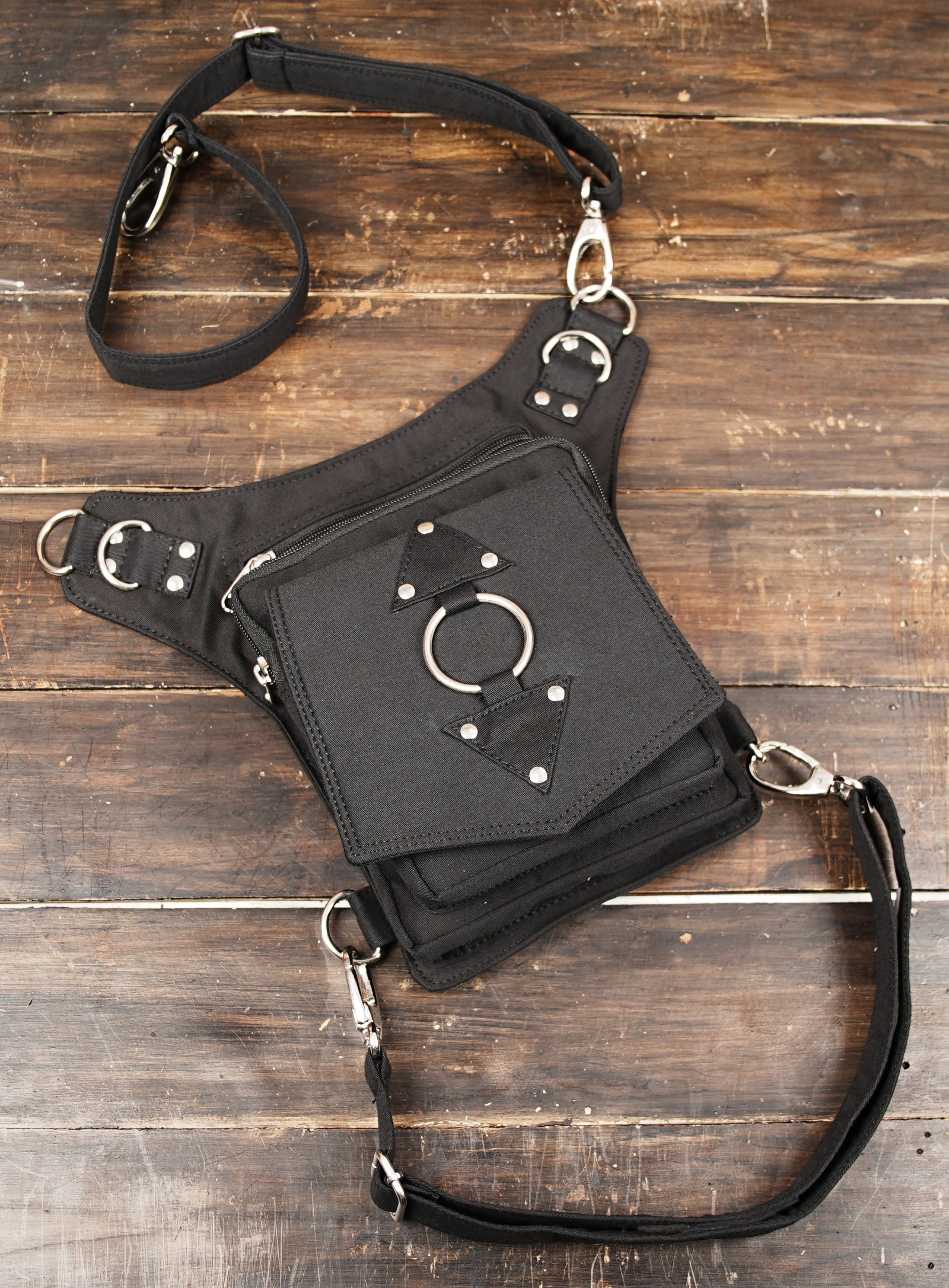 Black festival leg bag with thigh support strap and multi pocket organizer