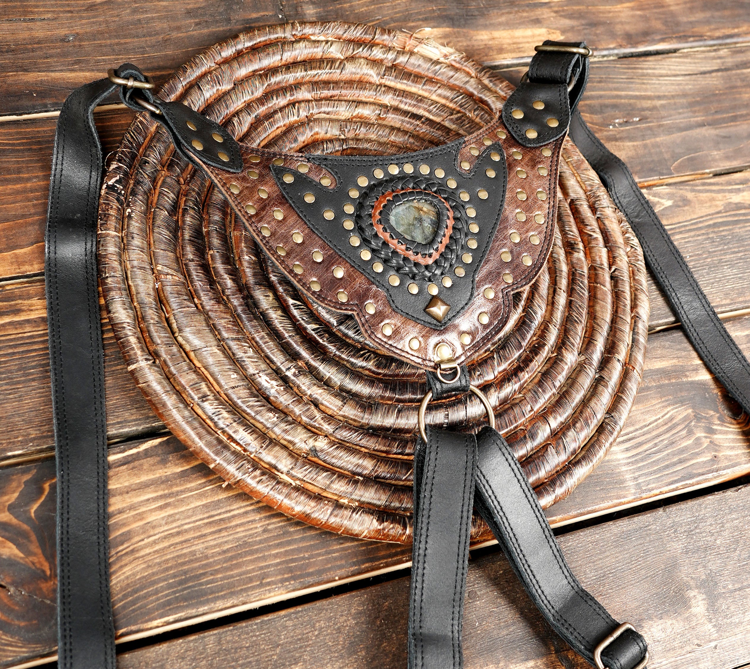 “Black and brown leather holster bag set with tribal-style gemstone decorations”