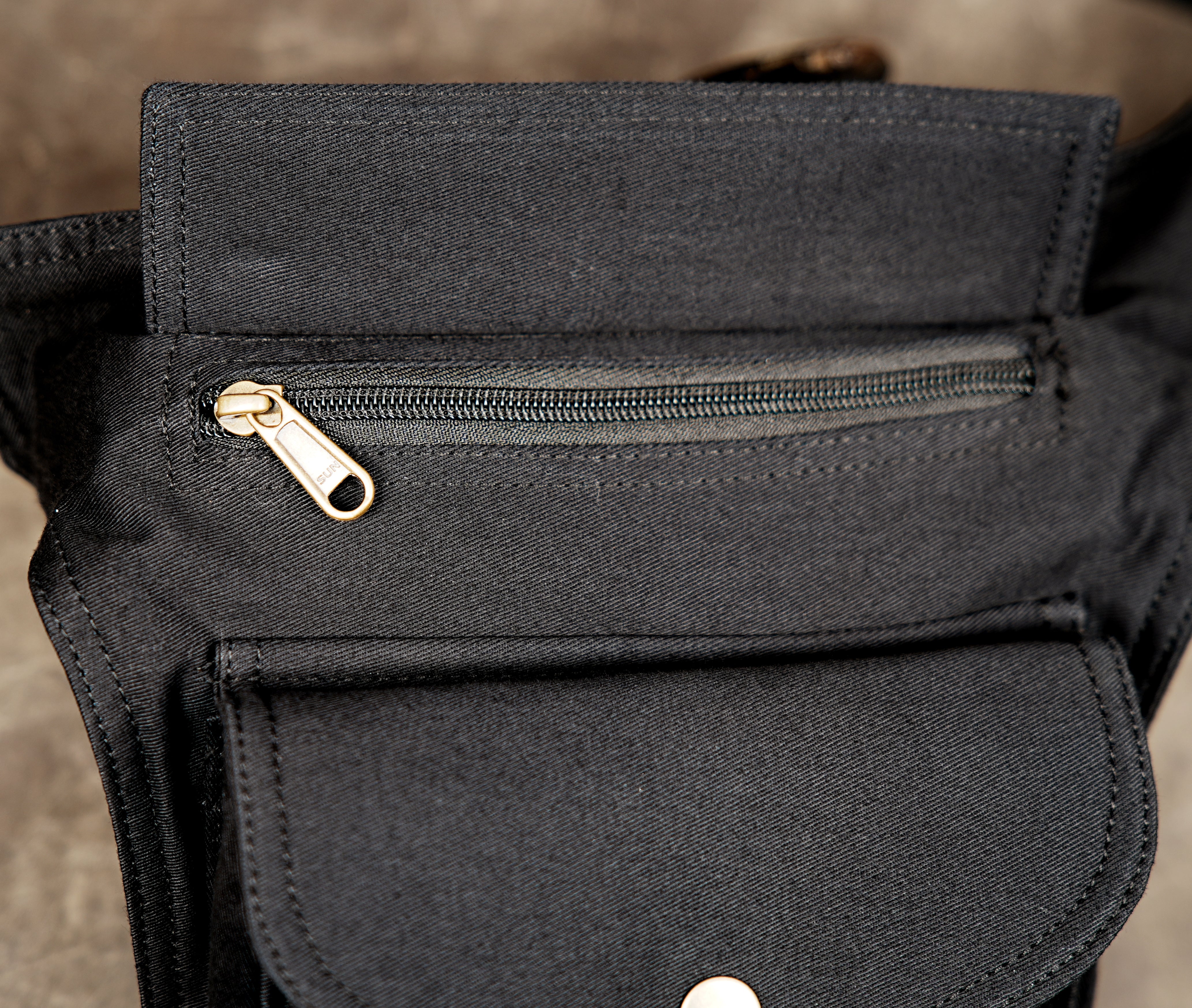 Black drop leg pouch with waist strap and adjustable thigh buckle.