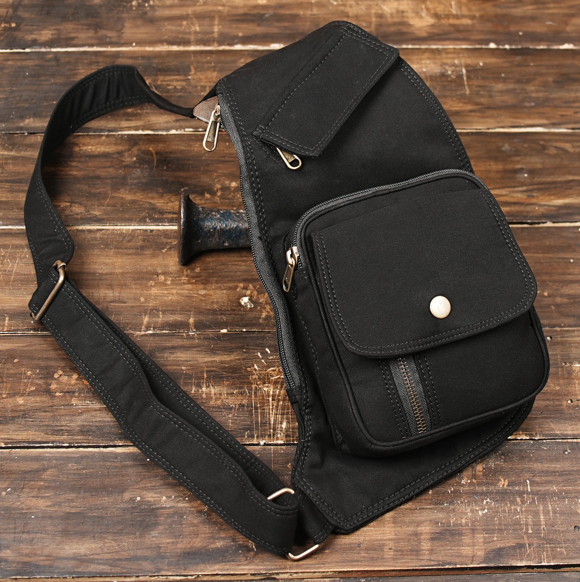 Versatile single strap chest bag with a distinctive front pocket layout