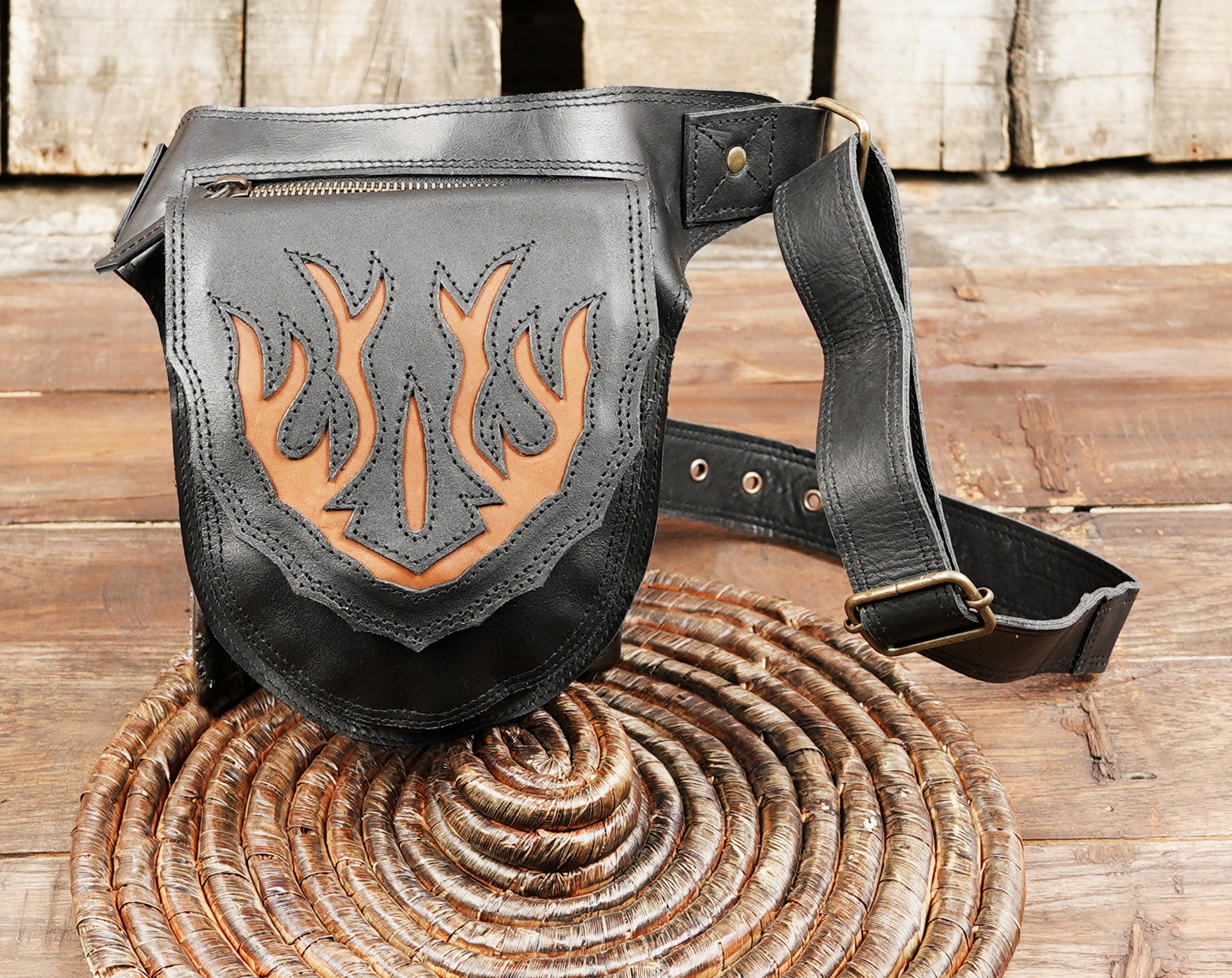 Unisex leather hip bag with fire motif.