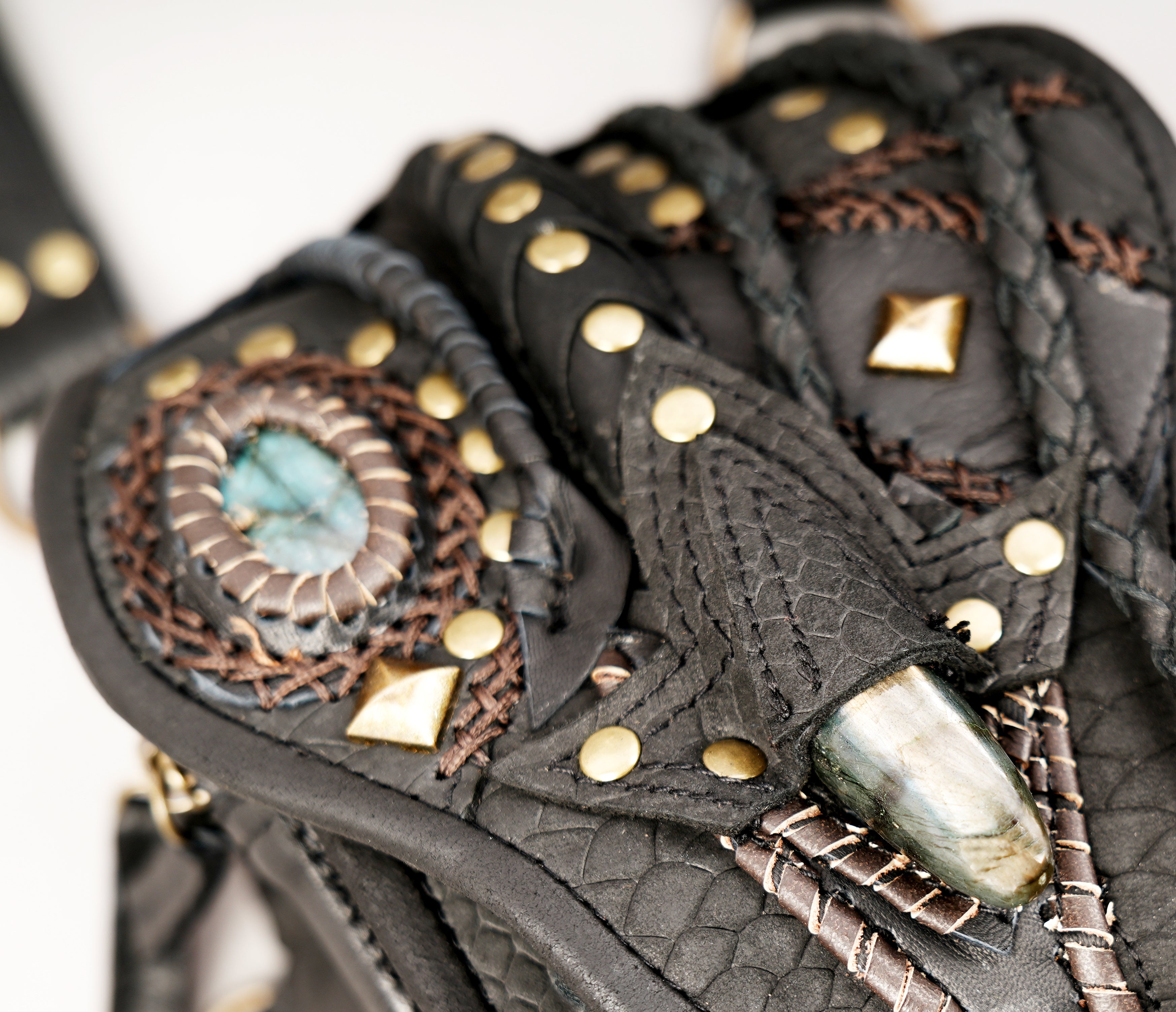 Black leather shoulder holster bag with decorative stone accent