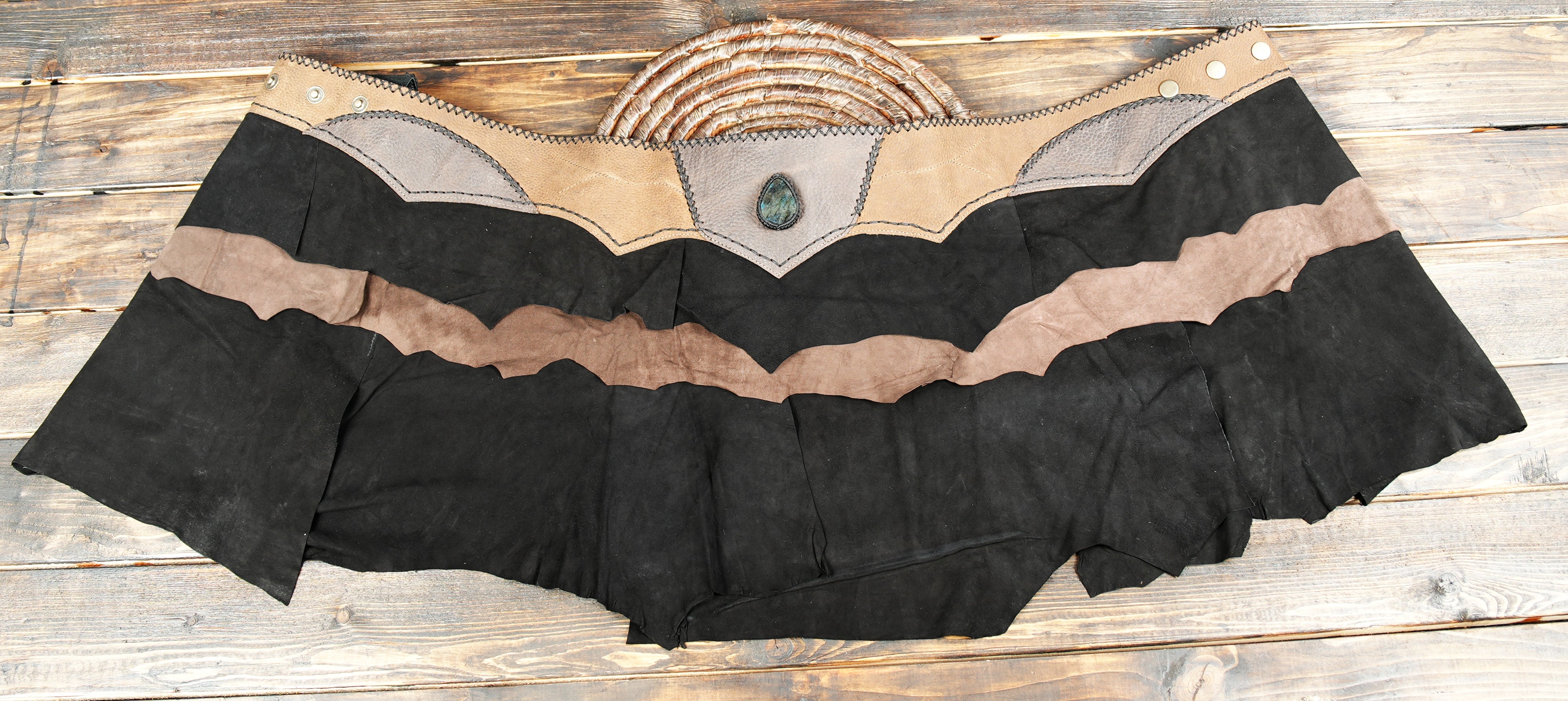 Festival leather skirt with asymmetrical raw hem and gemstone detail
