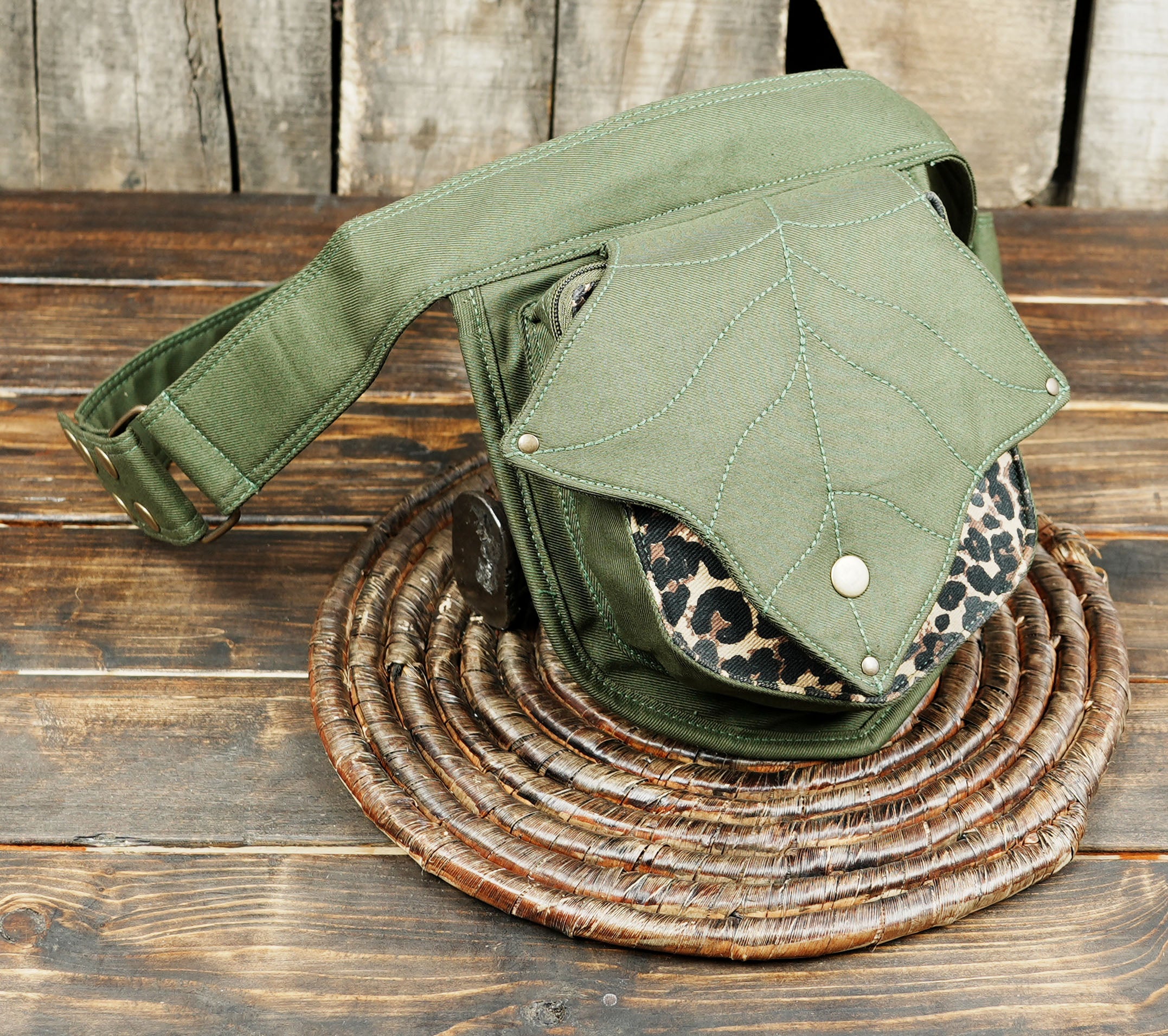 Adjustable olive green waist pack ideal for travel, hiking, and concerts