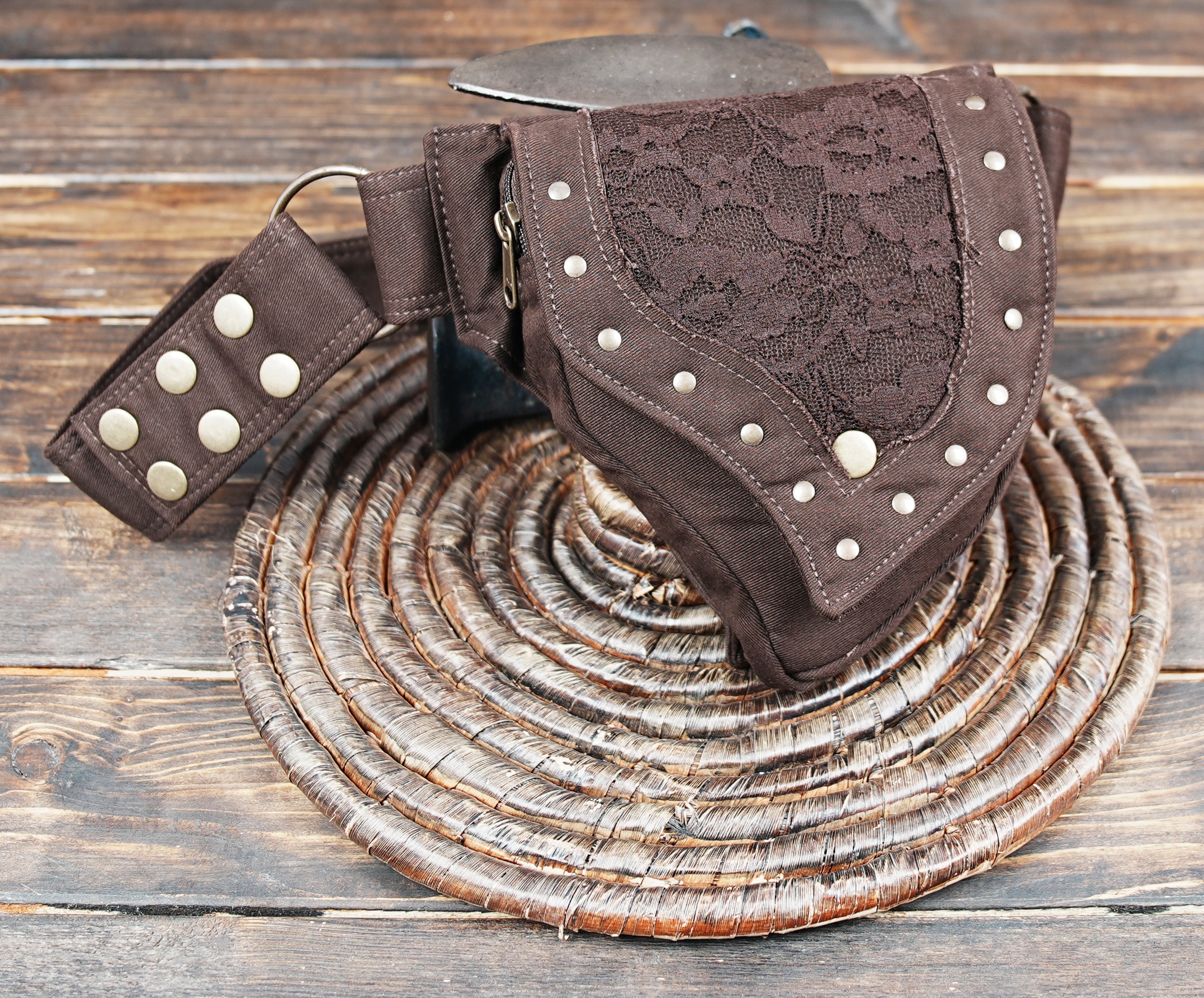 Close-up of lace overlay and studs on brown hip bag