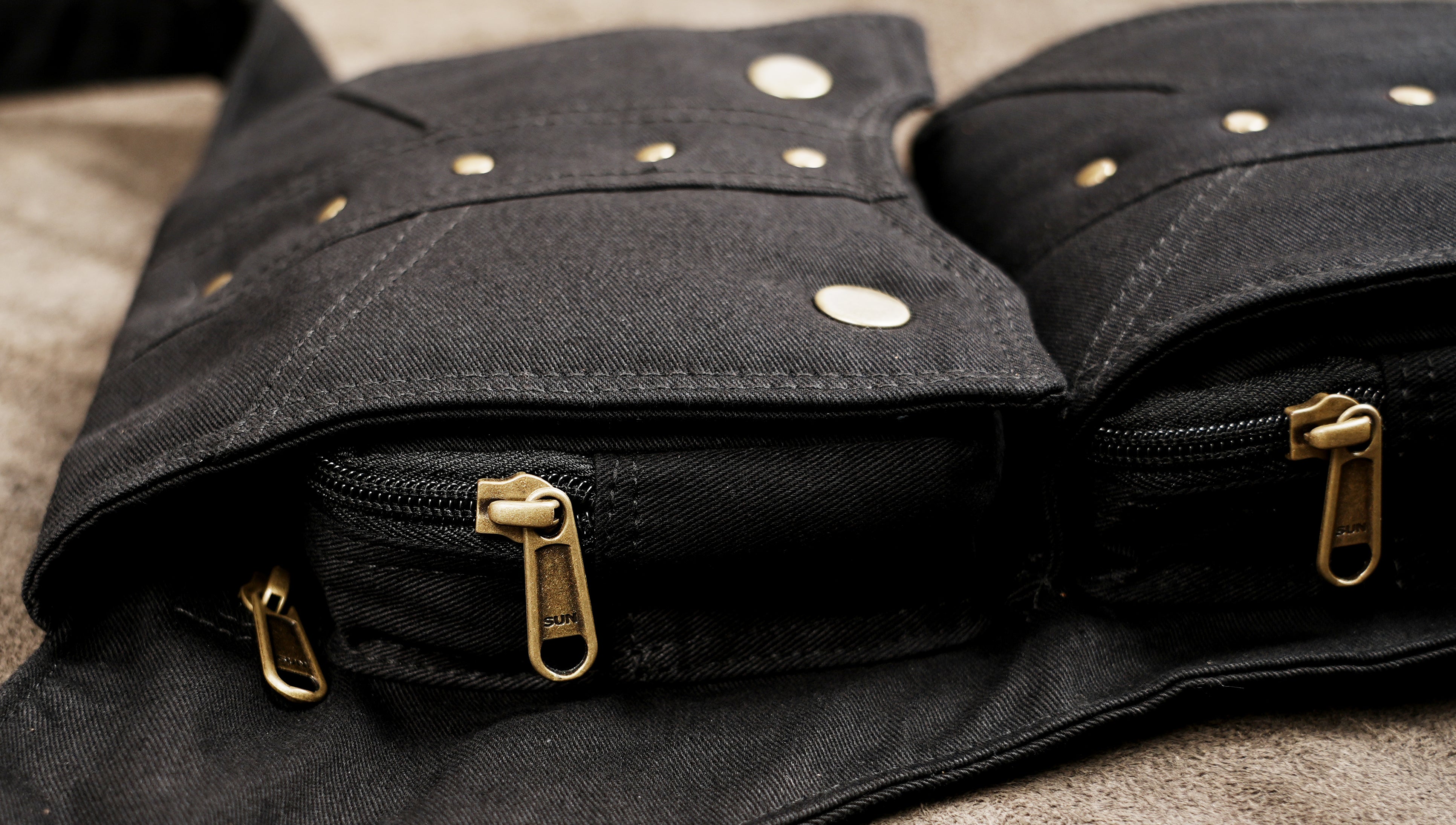 Black steampunk thigh bag with adjustable leg strap, flat lay view