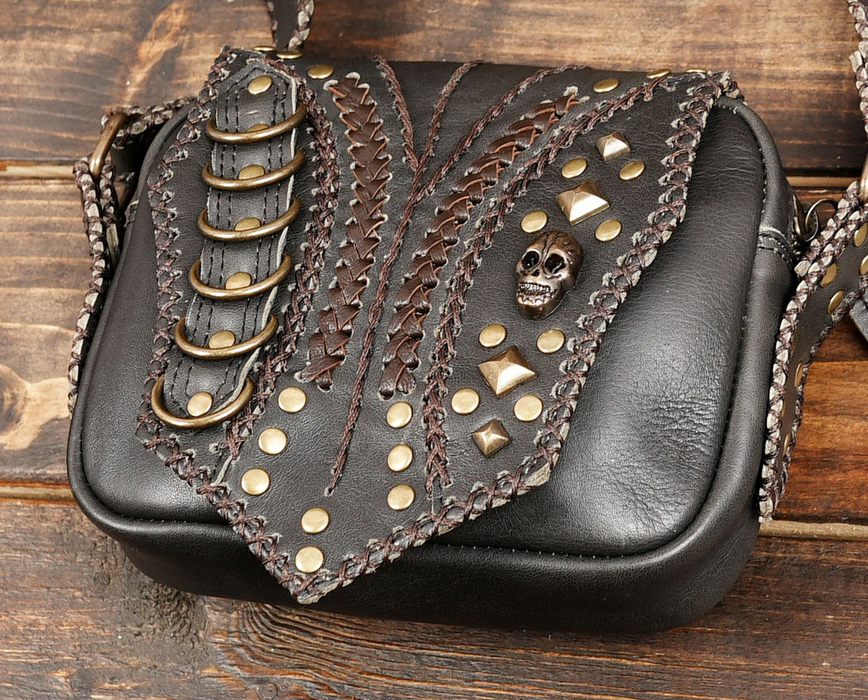 Steampunk-style leather shoulder holster with stud detailing

