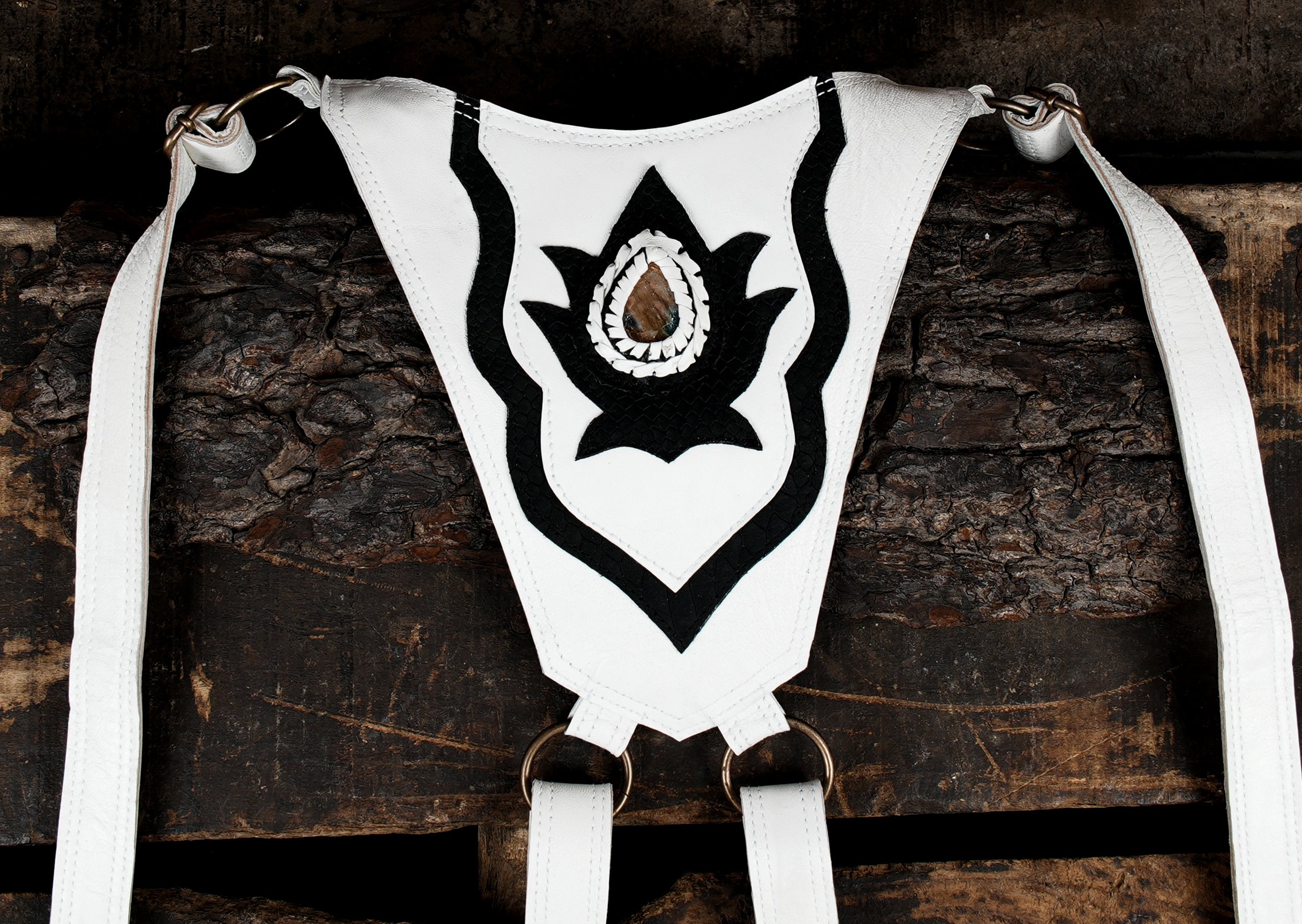 “Festival holster in white leather with bold black patterns and center gemstone”