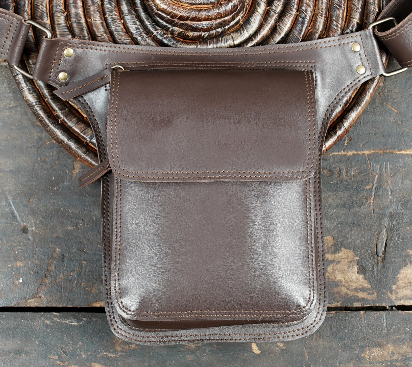 Brown leather belt bag with adjustable strap and roomy pocket