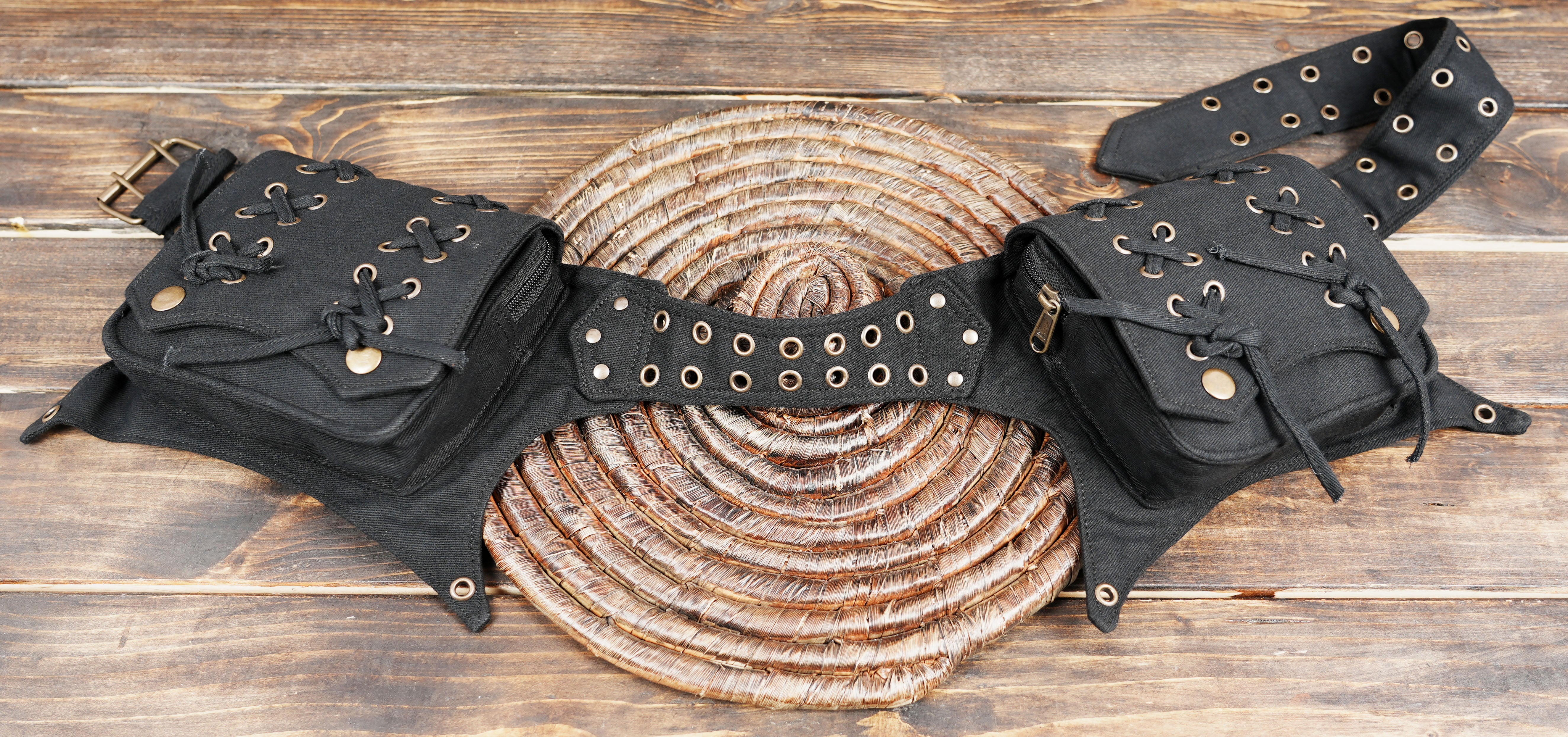 Alternative fashion utility belt with two zippered pockets and lace-up accents.