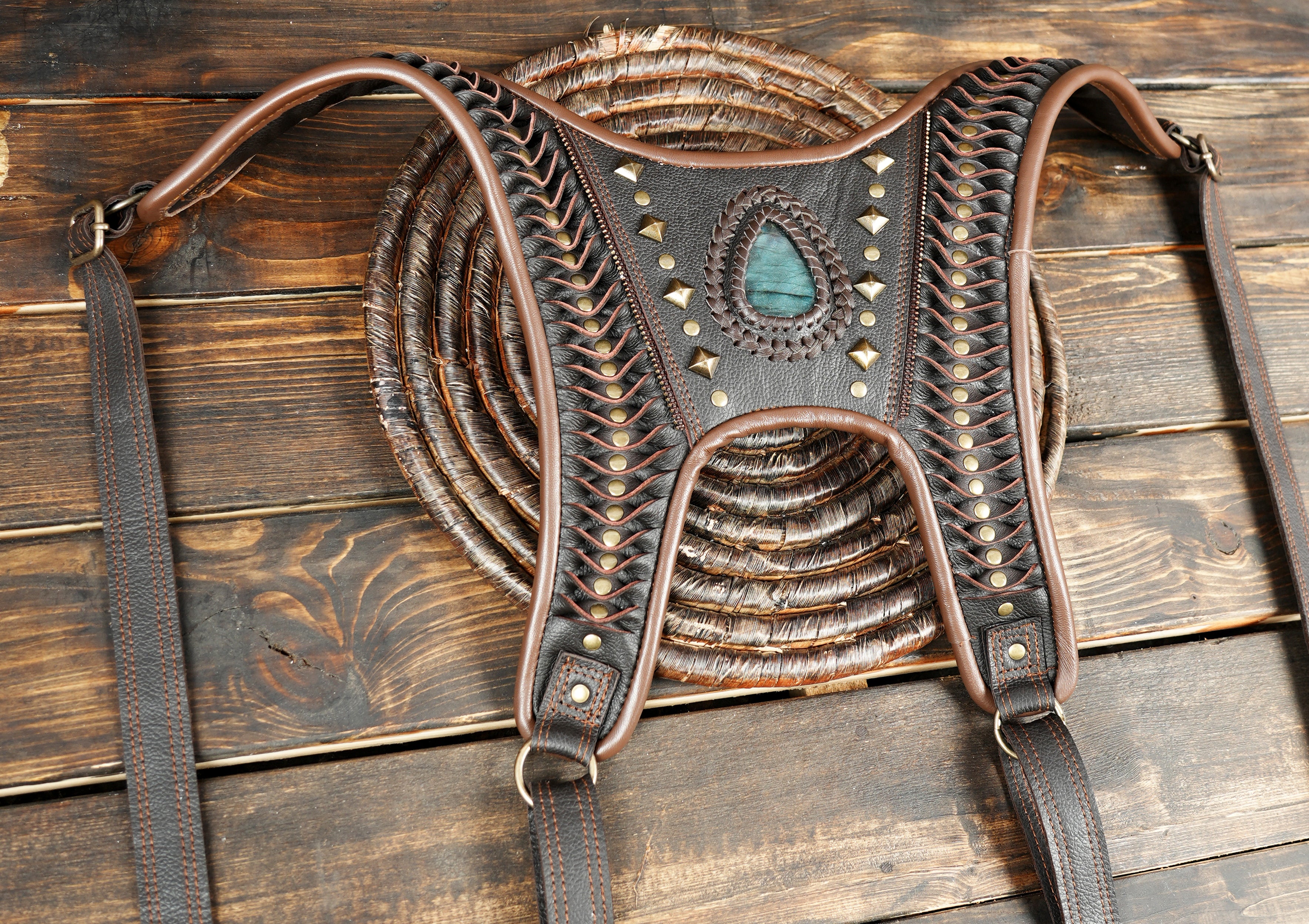 “Artisan leather festival holster featuring textured panels and gemstone accents”