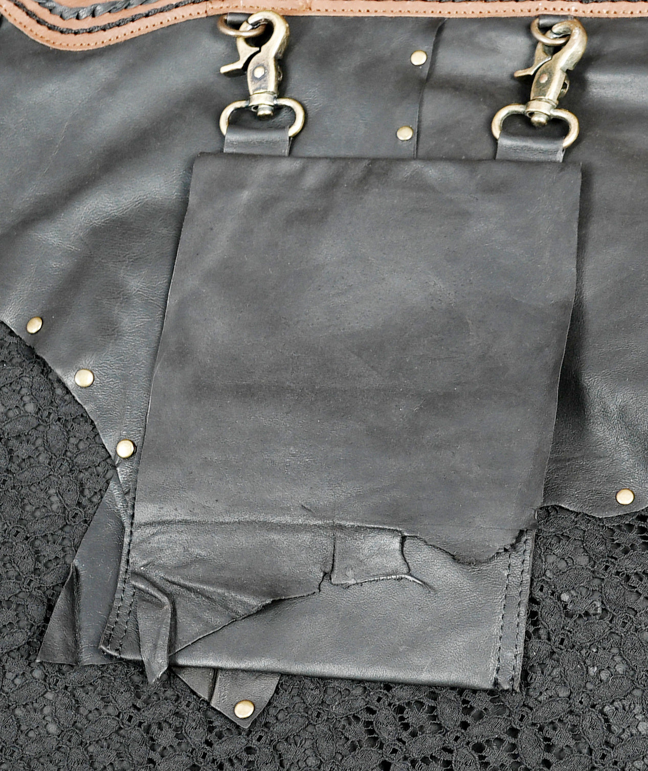 Boho leather skirt with decorative brass studs.