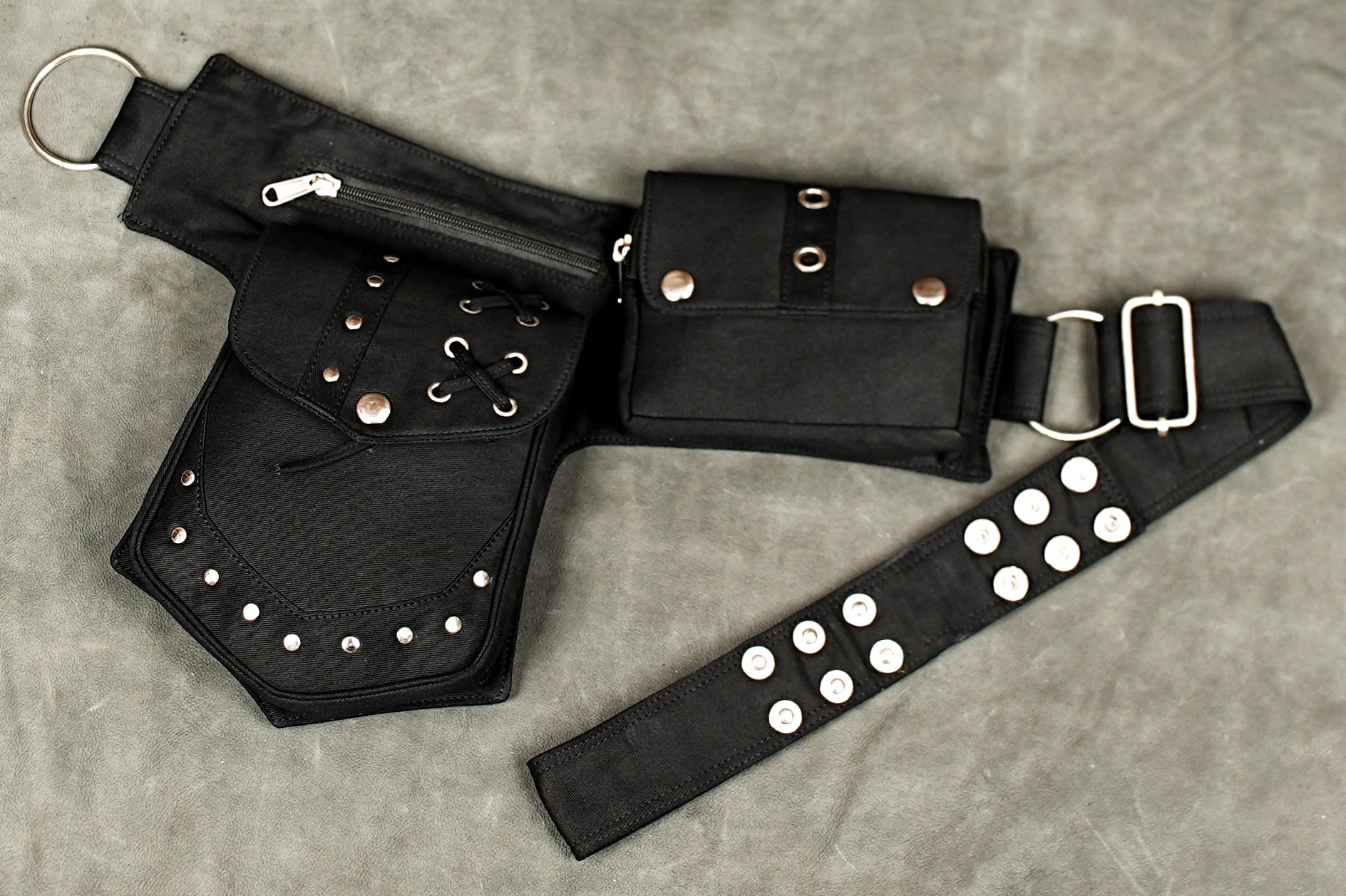 Women's black cotton waist bag belt with zip pocket and studded flap pockets for festival outfits.