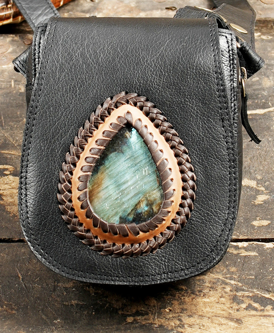 Artisan dual holster leather crossbody bag on rustic wood background