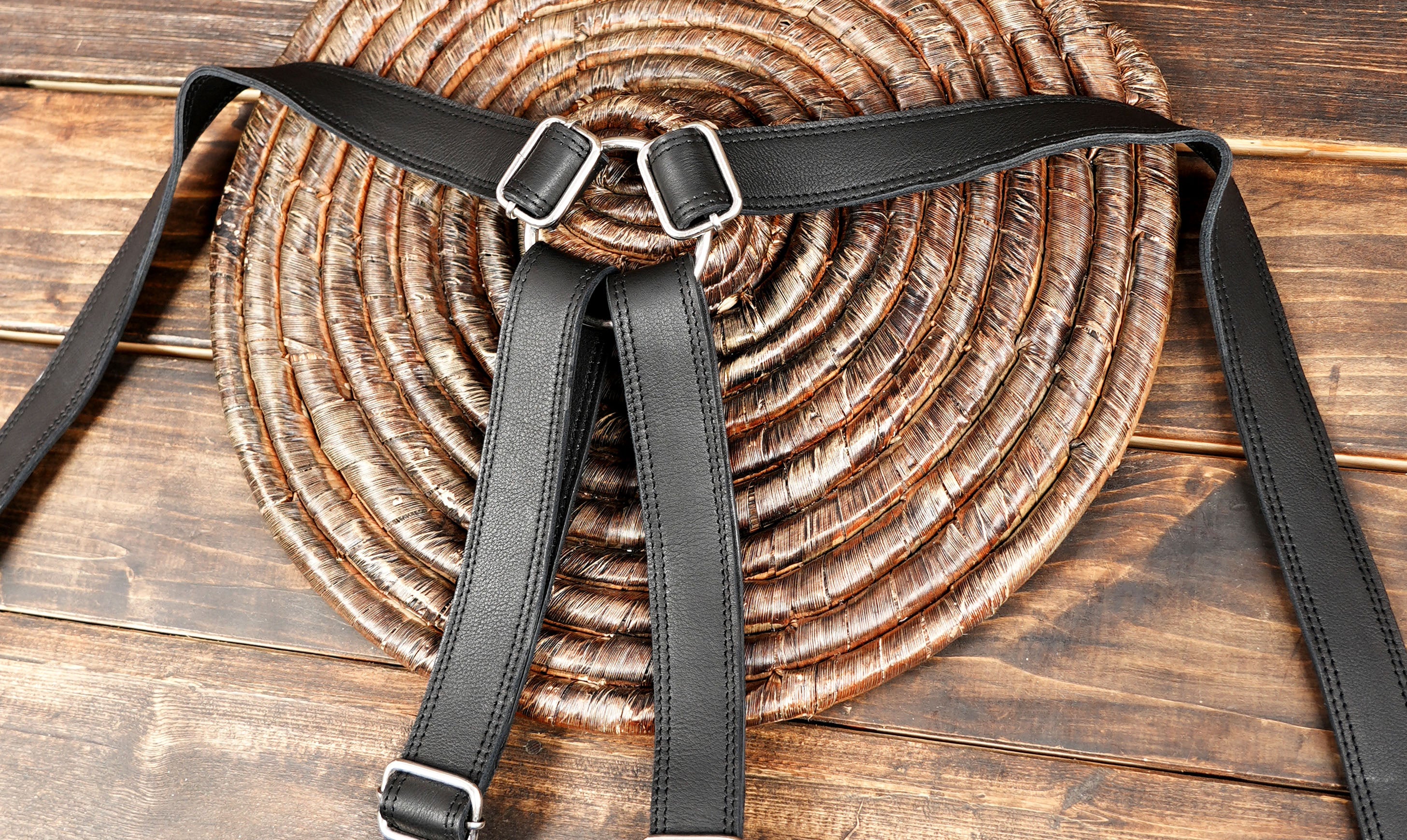 Adjustable black leather holster with secure buckle closures