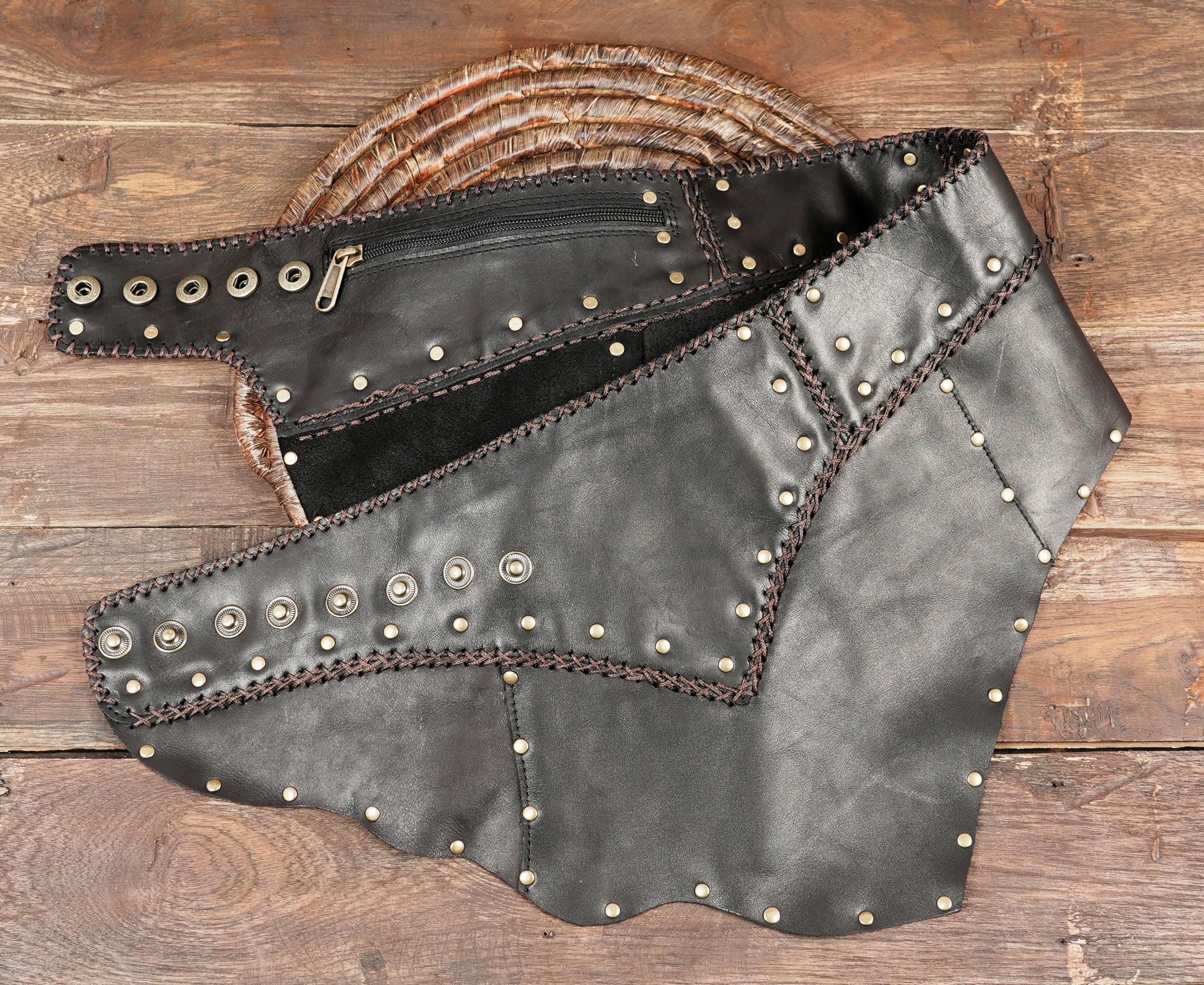 “Black leather studded skirt with asymmetrical hem, handmade gothic steampunk fashion.”