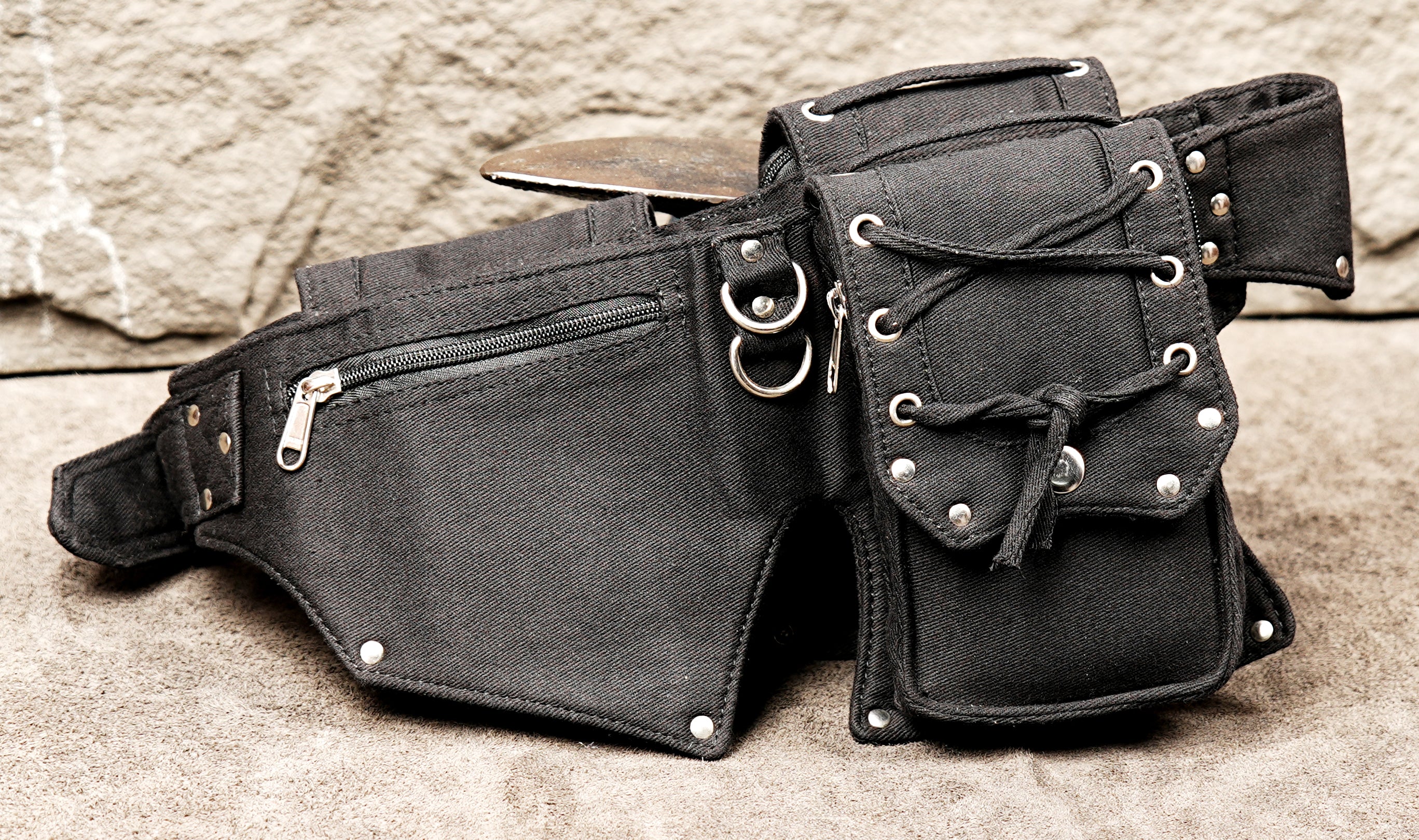 Premium alternative fashion waist pack with a raw, industrial-style utility aesthetic.