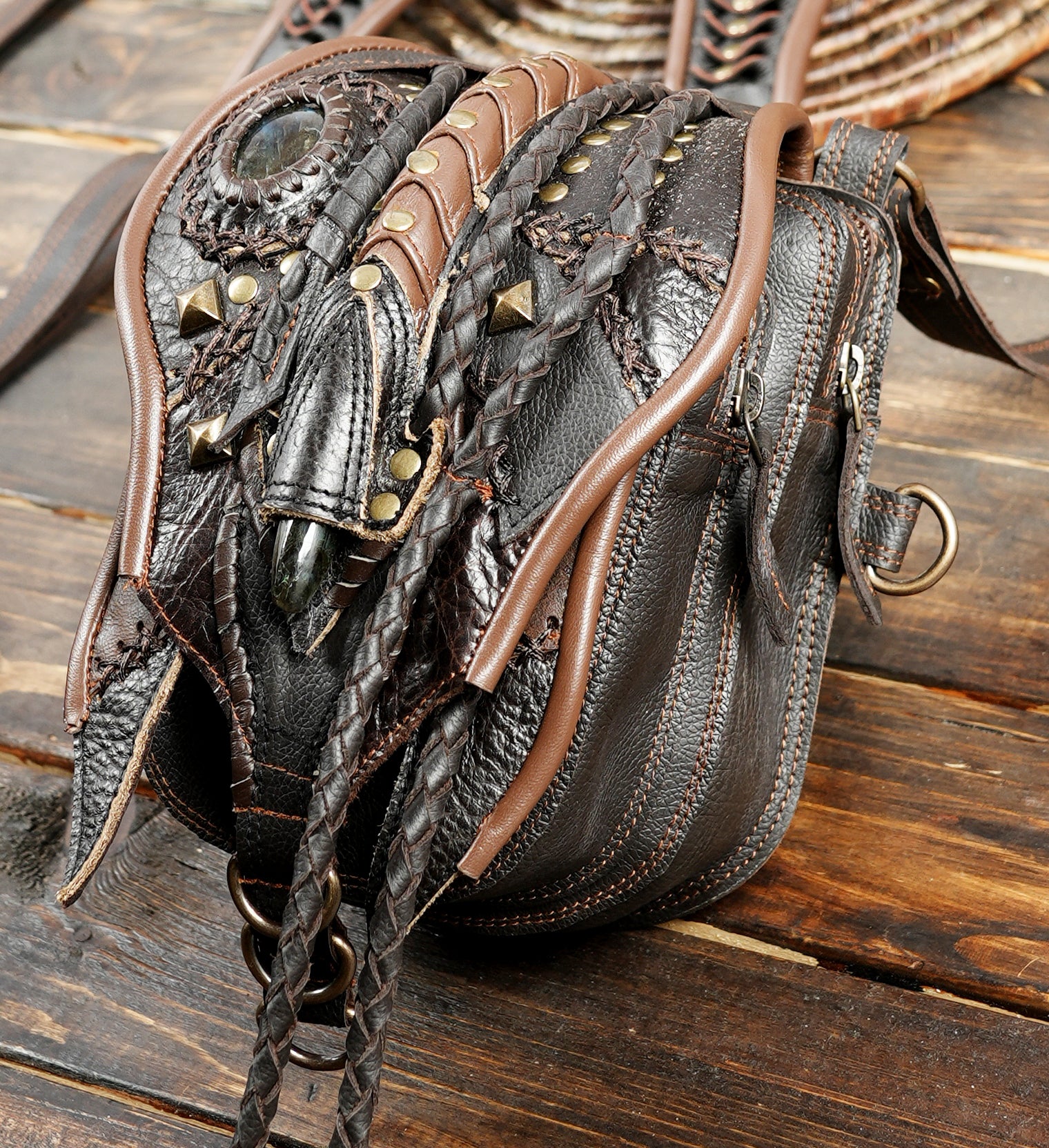 “Dark brown leather double holster with long tassels and ornate tribal patterns”