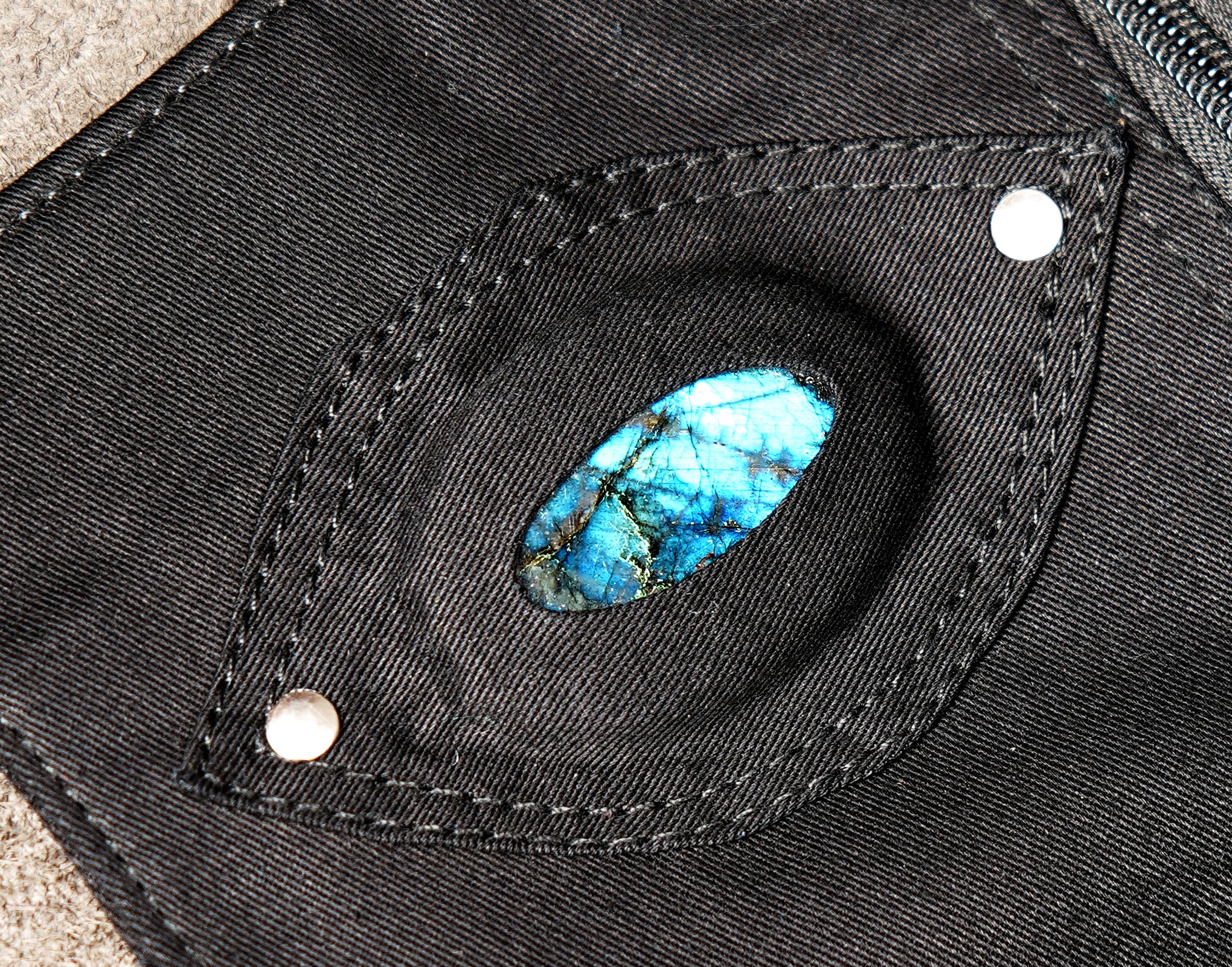 Unisex black hip belt bag featuring secure snap-button pockets and silver buckle.