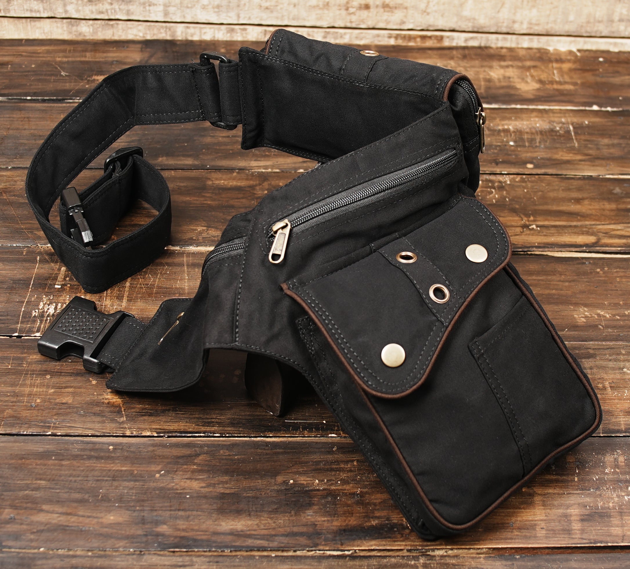 Side angle view of black and brown leather hip pouch