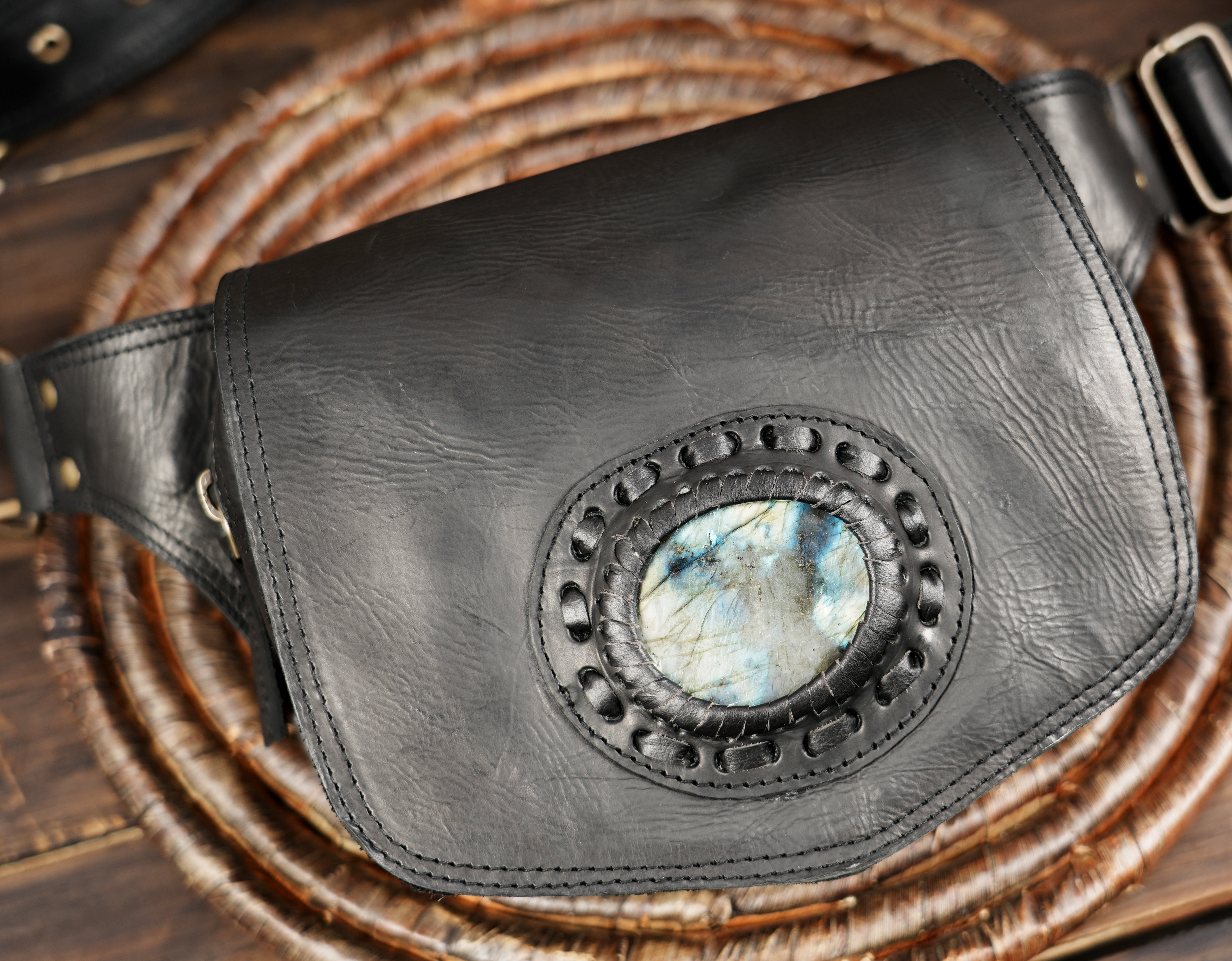 Stylish black leather fanny pack featuring a round stone embellishment