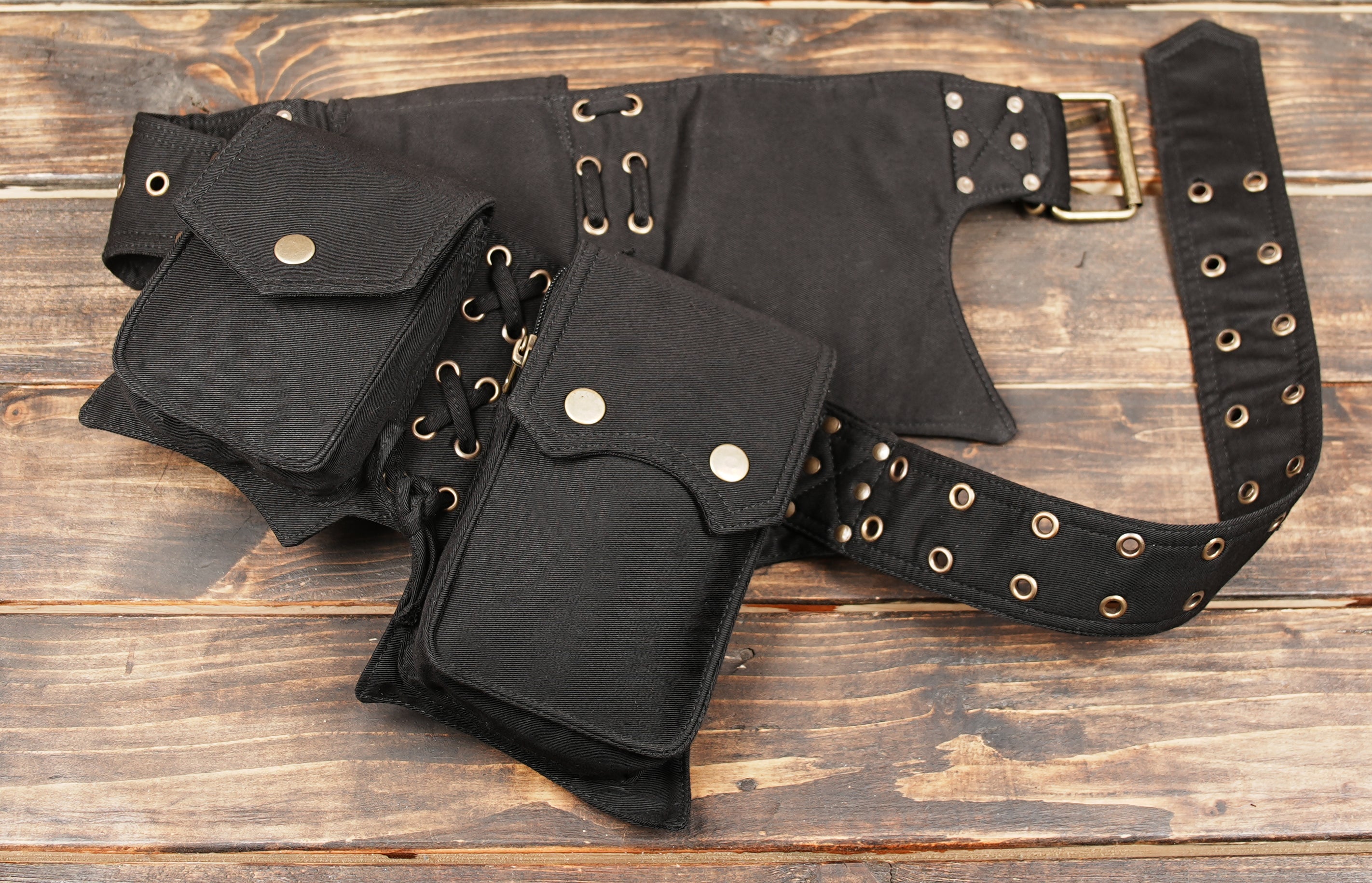 Utility leather multi pocket belt feature grommets and built