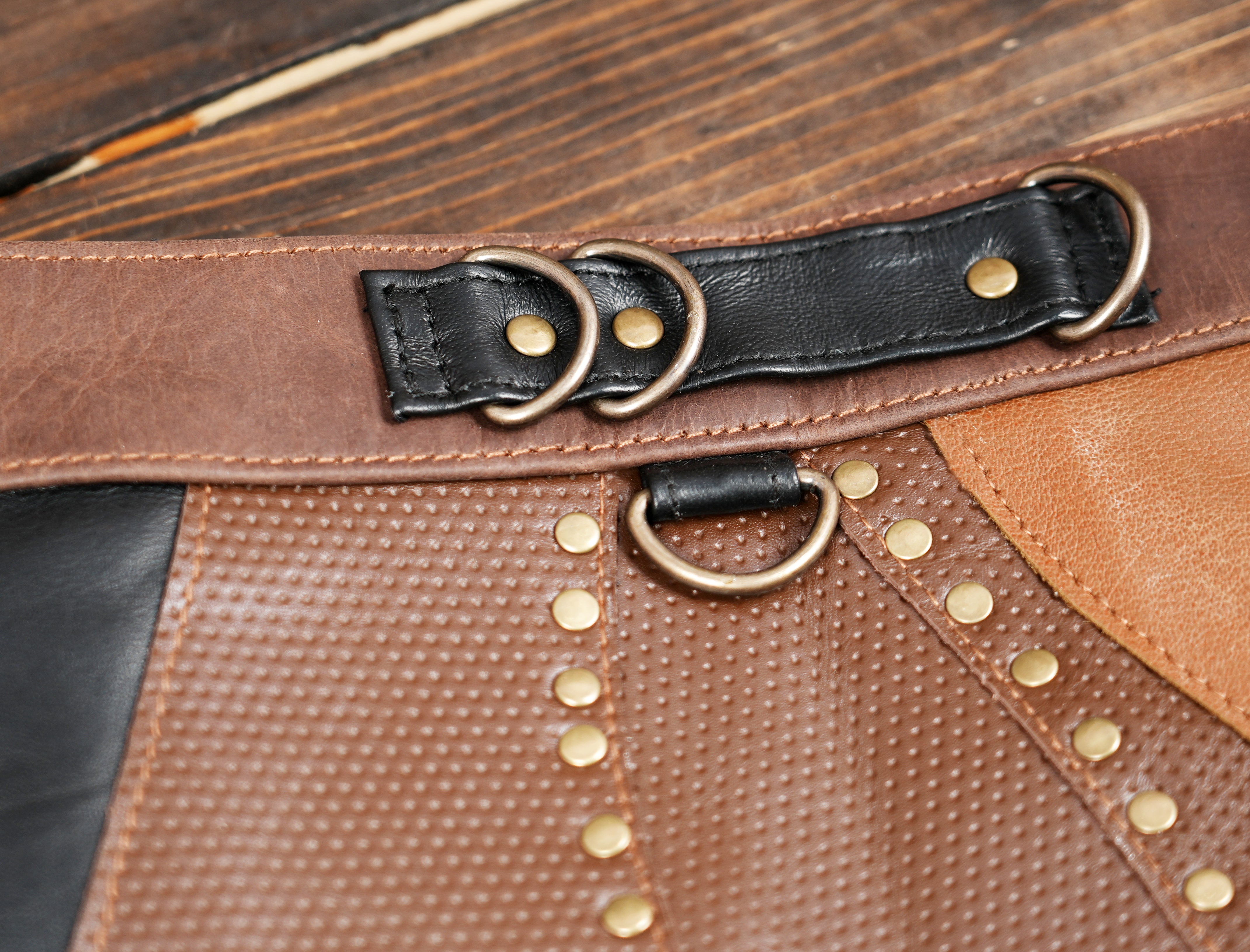 Premium leather skirt featuring artistic cut panels and front embellishment