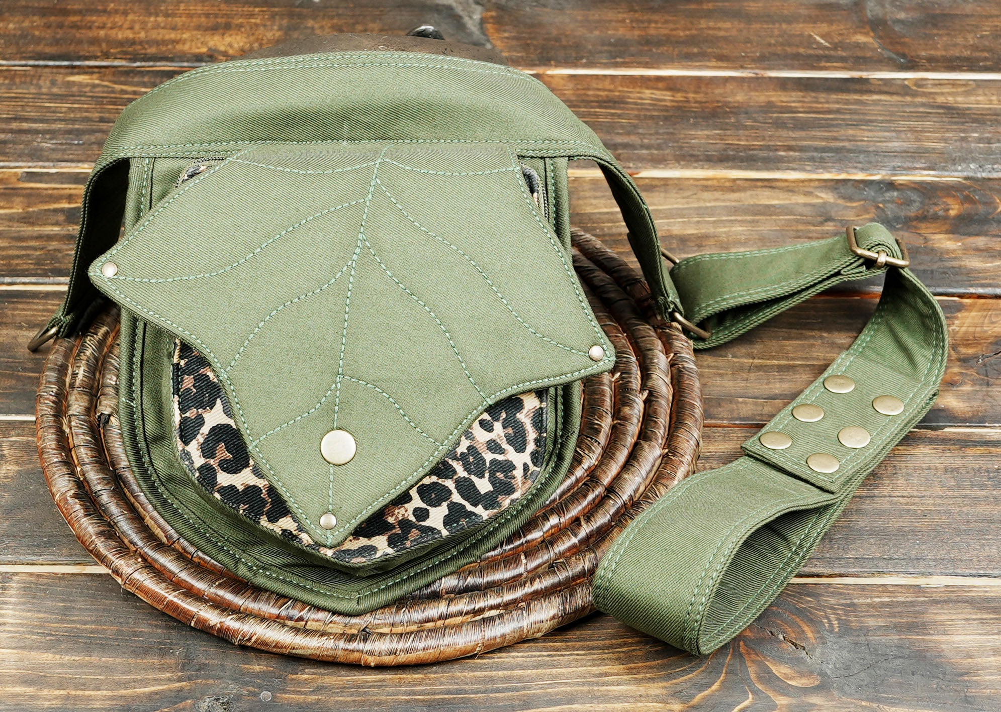 Artisan-made canvas hip bag with a distinctive leaf design and snap closure