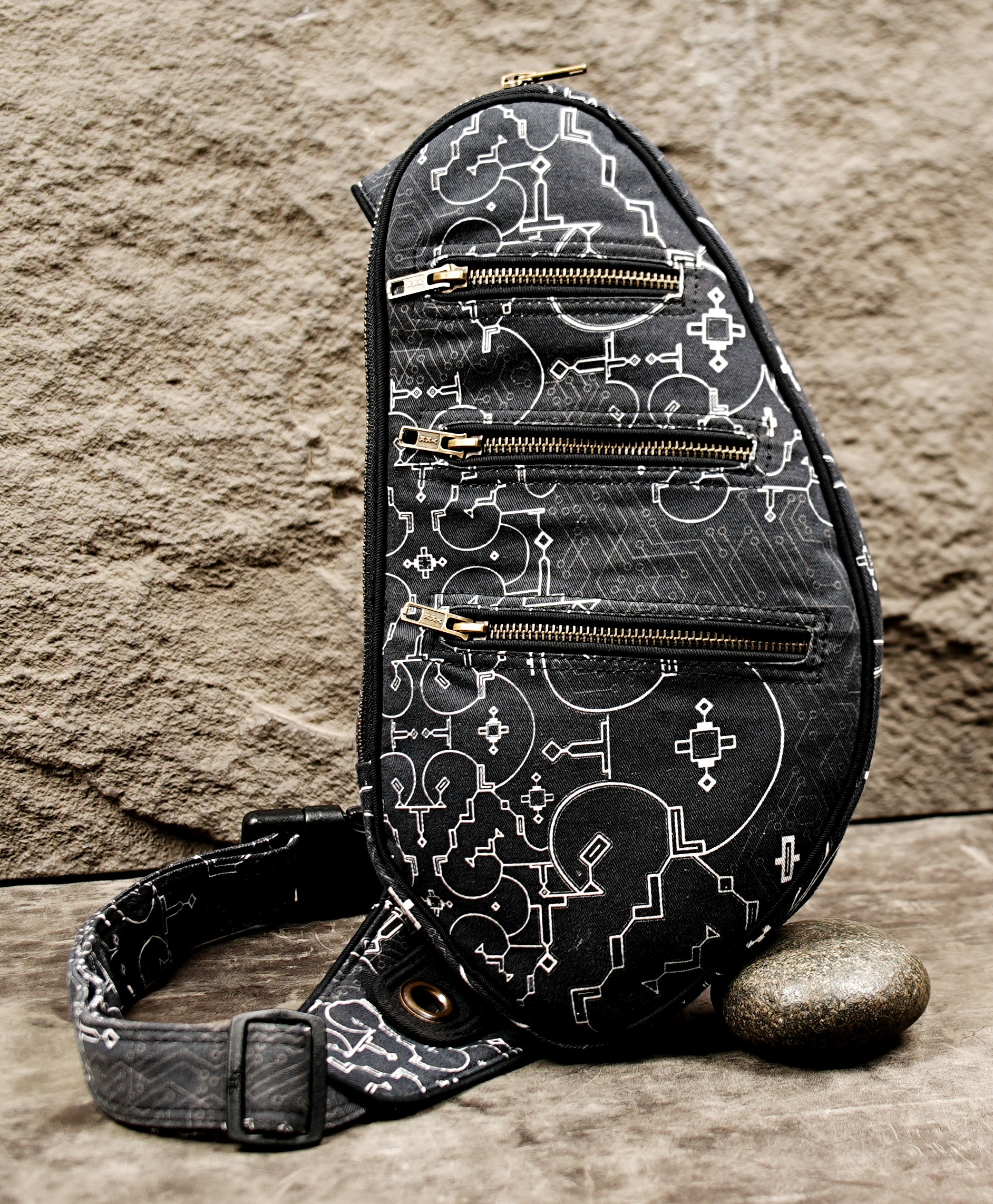 Unisex sling bag with side-release buckle and eyelet strap detail