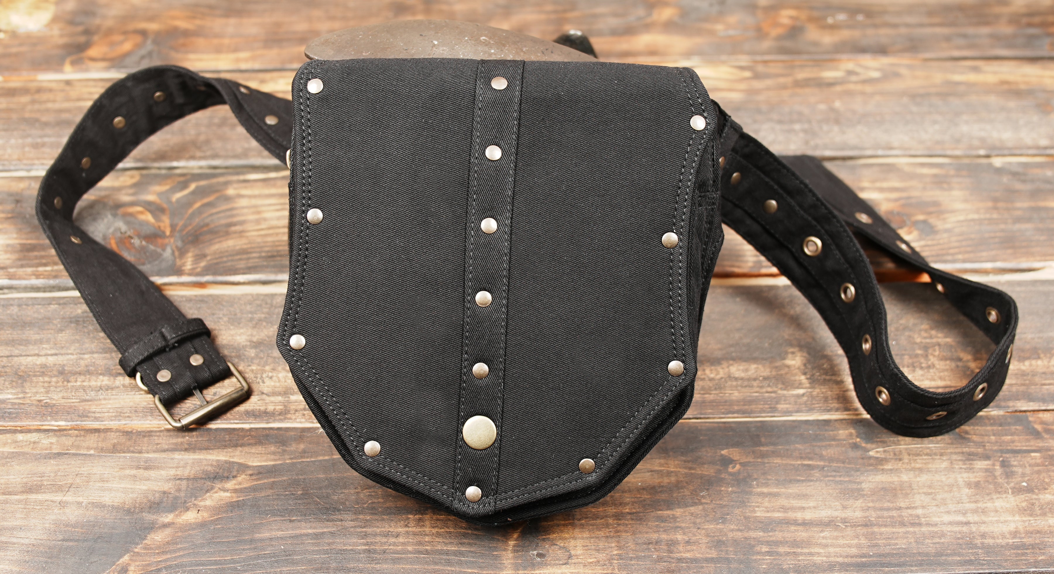 Black gothic waist bag with riveted flap and edgy design