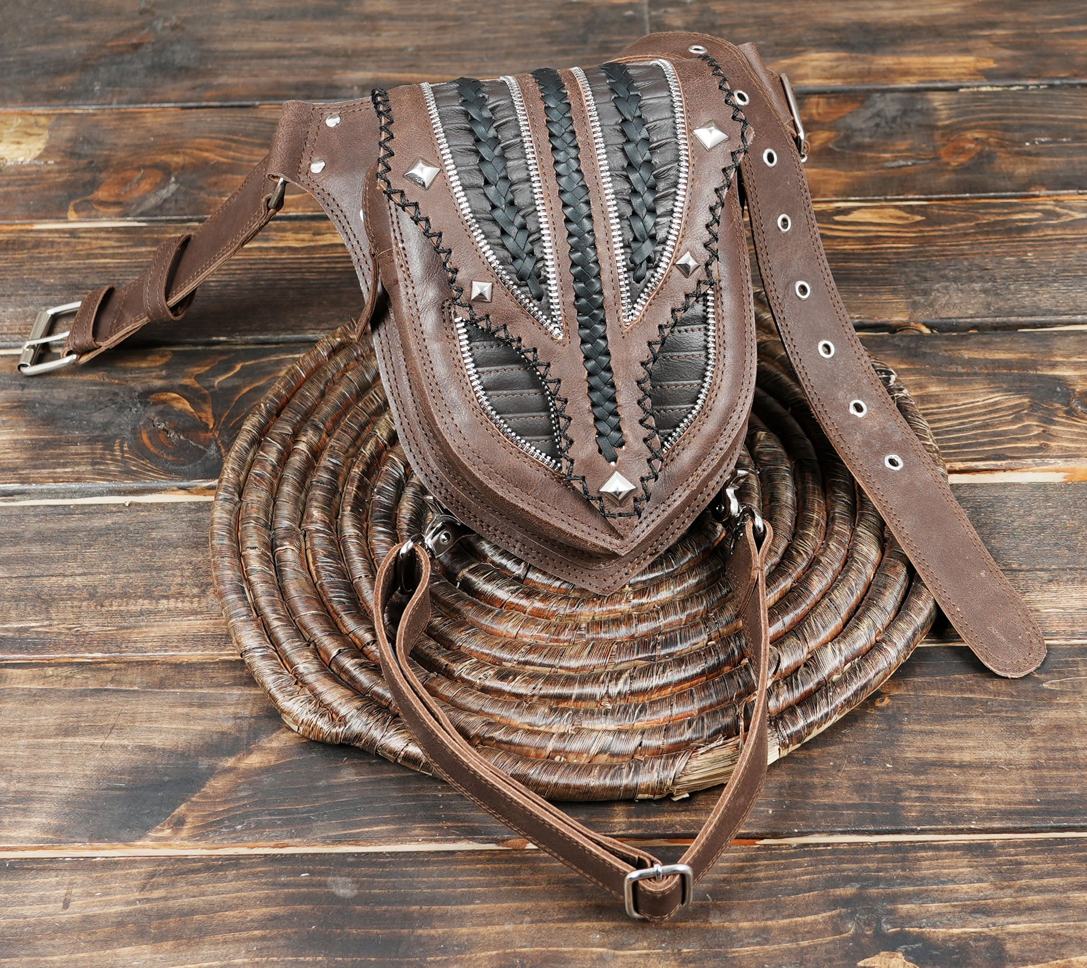 Double-strap leather belt with decorative stitching and metal studs.