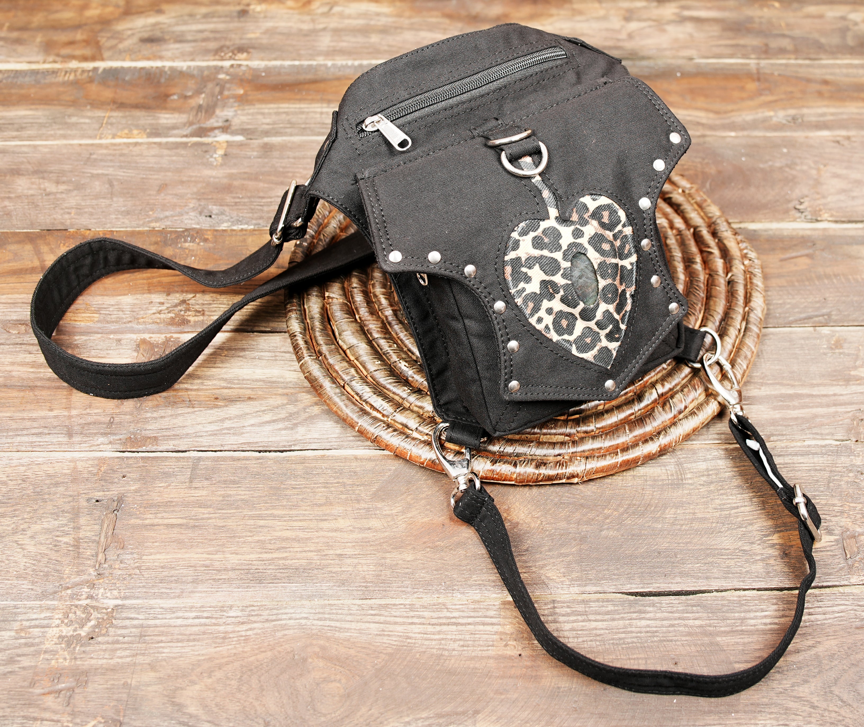 Unisex black canvas hip bag with secure leg harness and heart patch