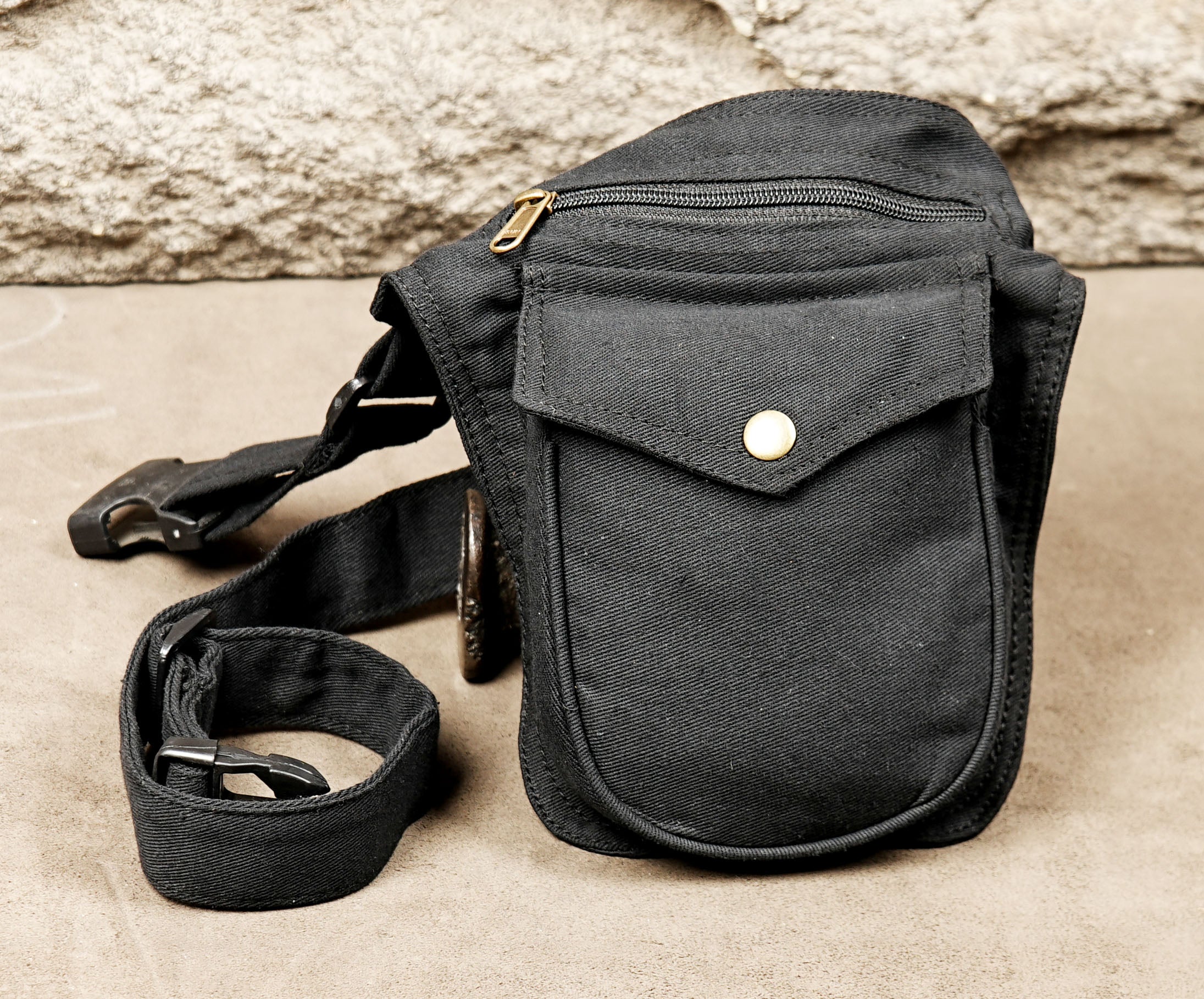 Black fanny pack with front zip and button flap closure