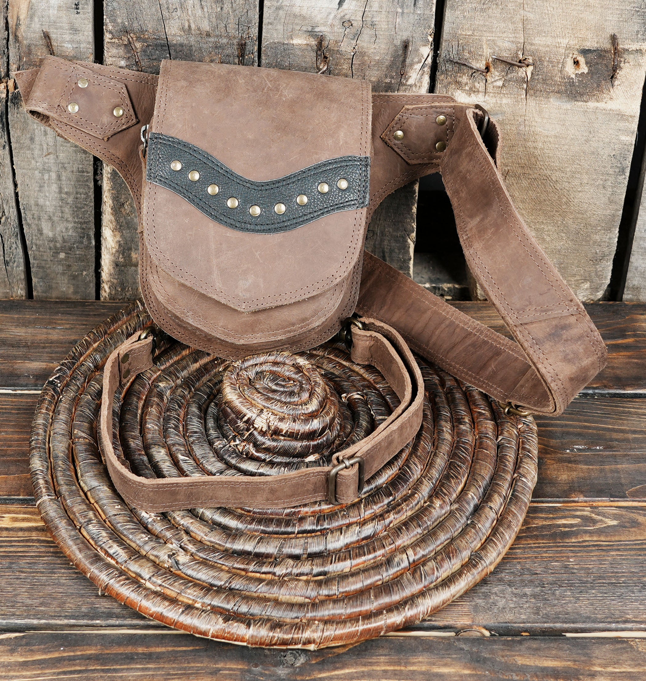 Made from genuine high-quality leather, it features an adjustable waist strap and thigh strap for a comfortable fit.