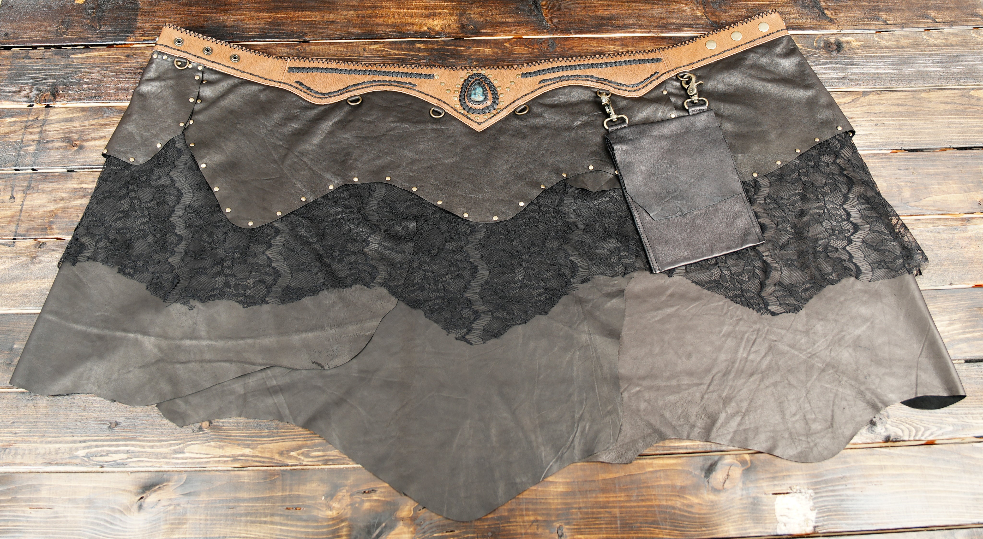 Layered leather and lace design with stud embellishments for a bold, stylish finish