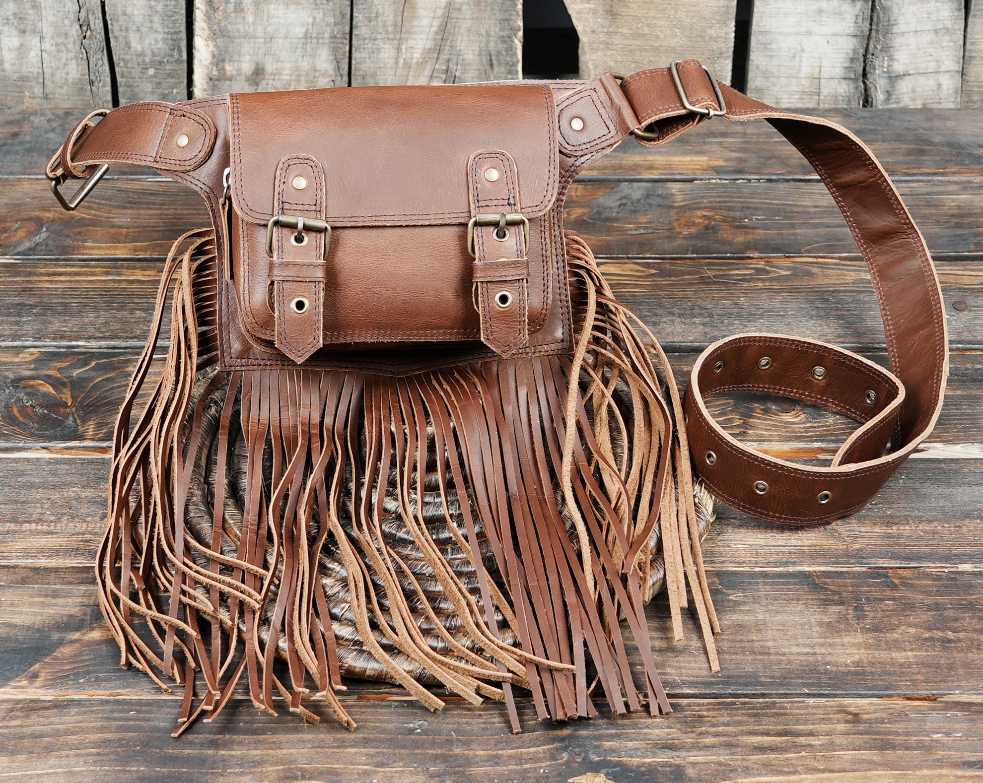 Artisan crafted leather waist pouch with brass hardware and fringe