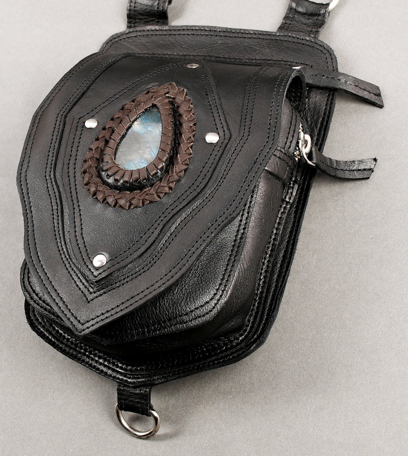 Handmade leather holster featuring natural stone centerpiece and long fringe