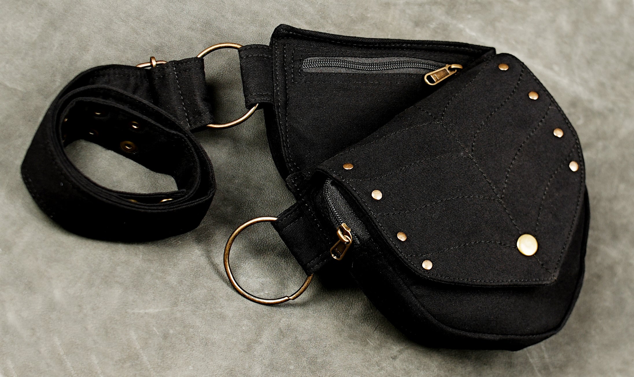Rustic black utility belt bag with quilted leaf stitching and brass snaps